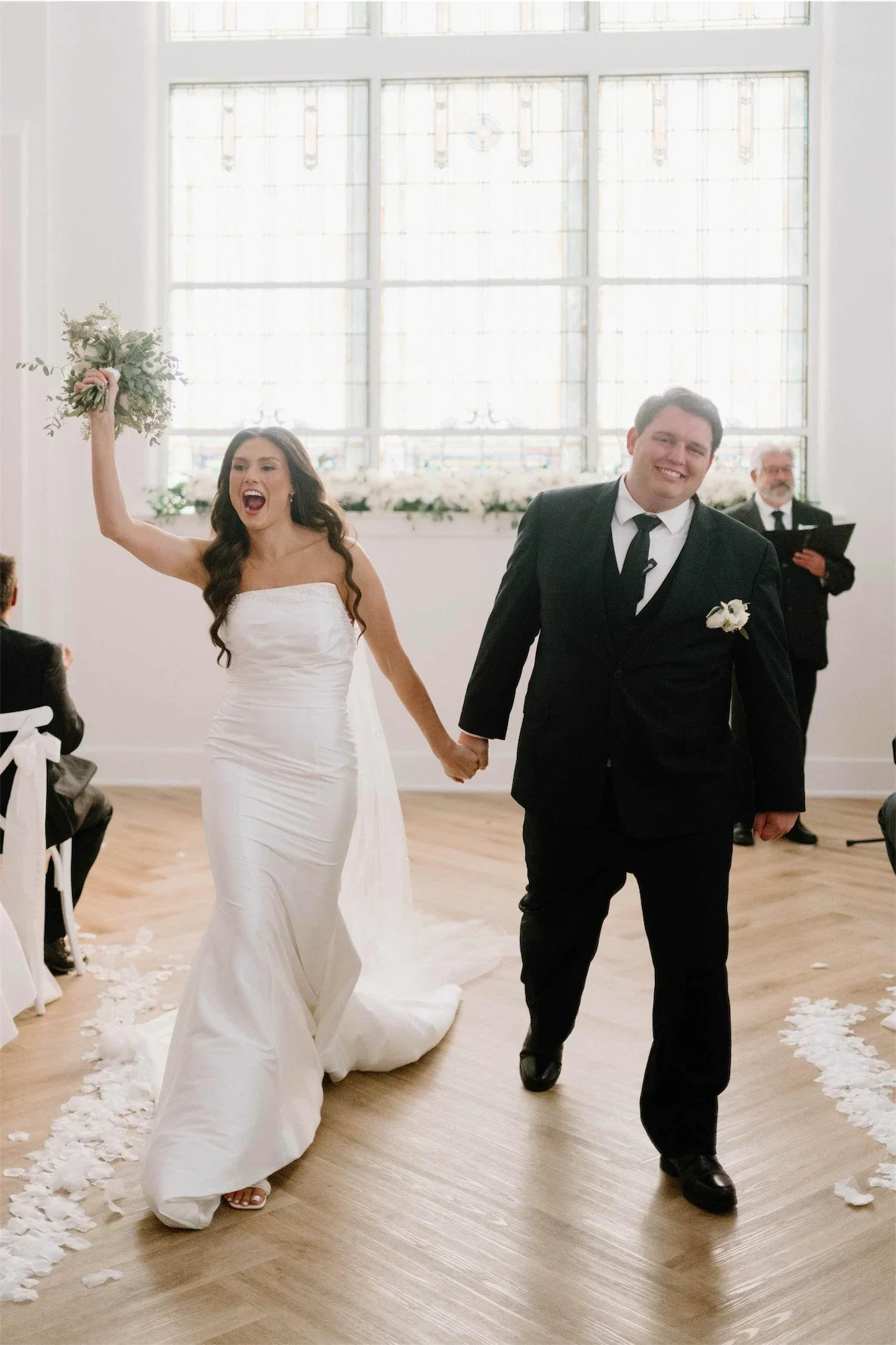 recessional-bride-cheering-bouquet-raised.webp