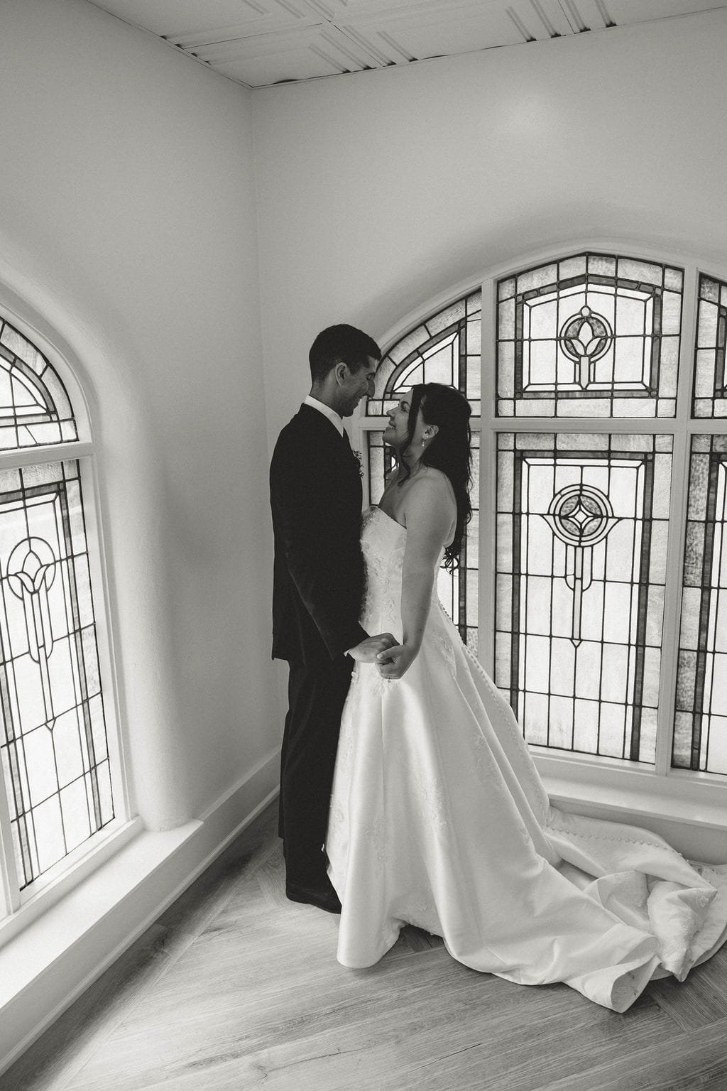bride-and-groom-gaze-at-each-other-chapel-black-and-white.jpg