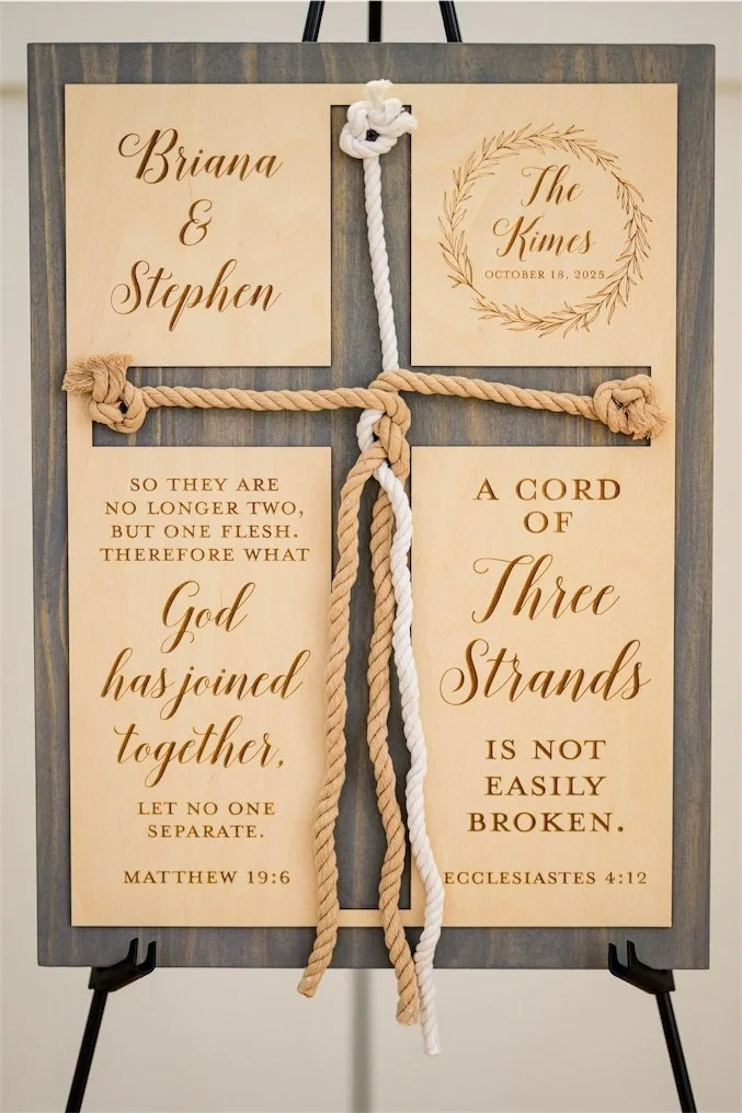 Wooden unity ceremony sign with a braided rope cross and cord of three strands scripture on an easel