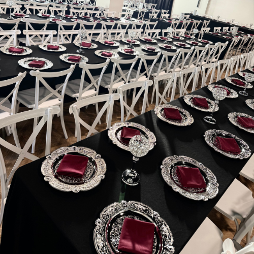 overhead view of several Gatsby reception tables lined with white cross back chairs