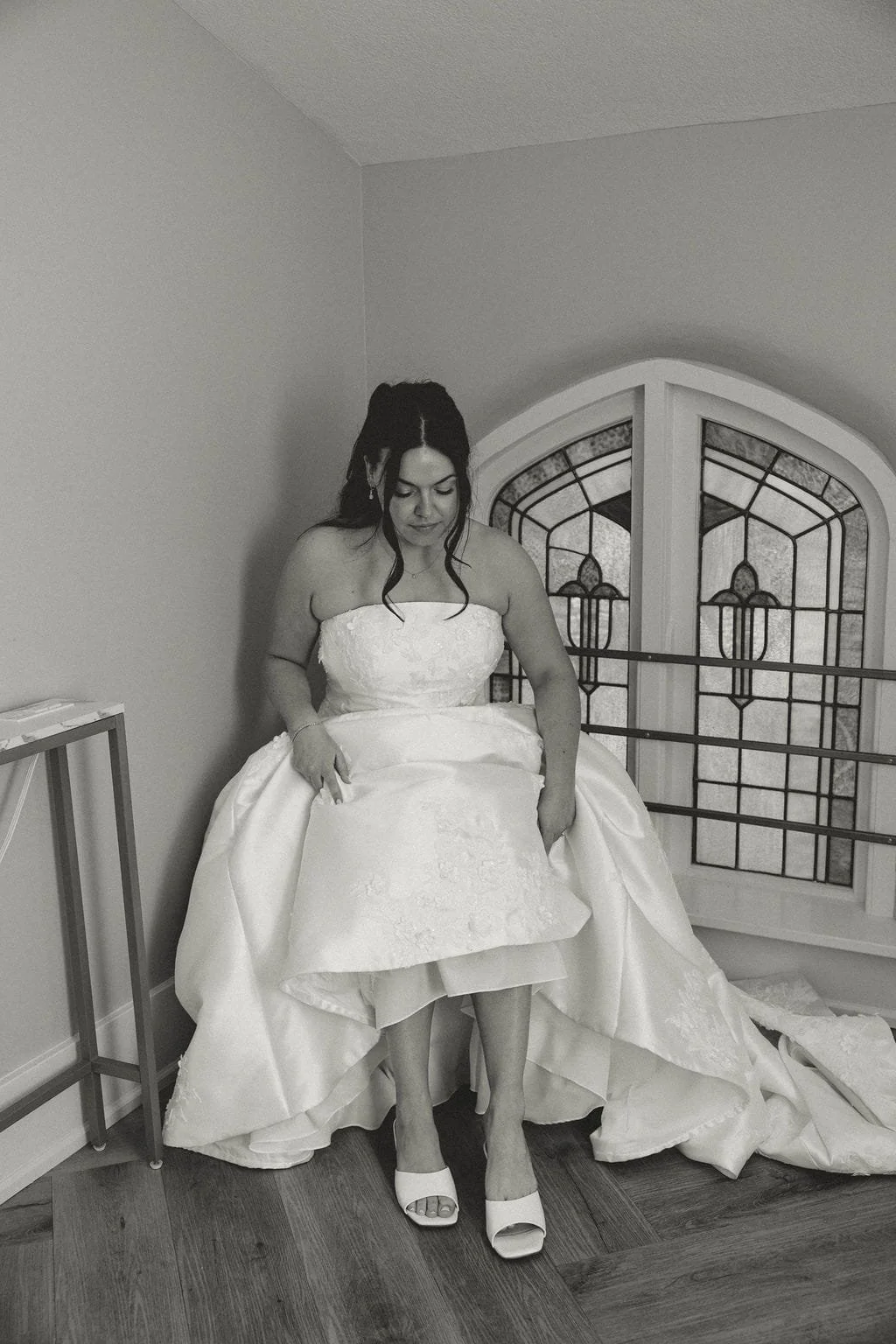 bride-puts-on-left-shoe-black-and-white.jpg