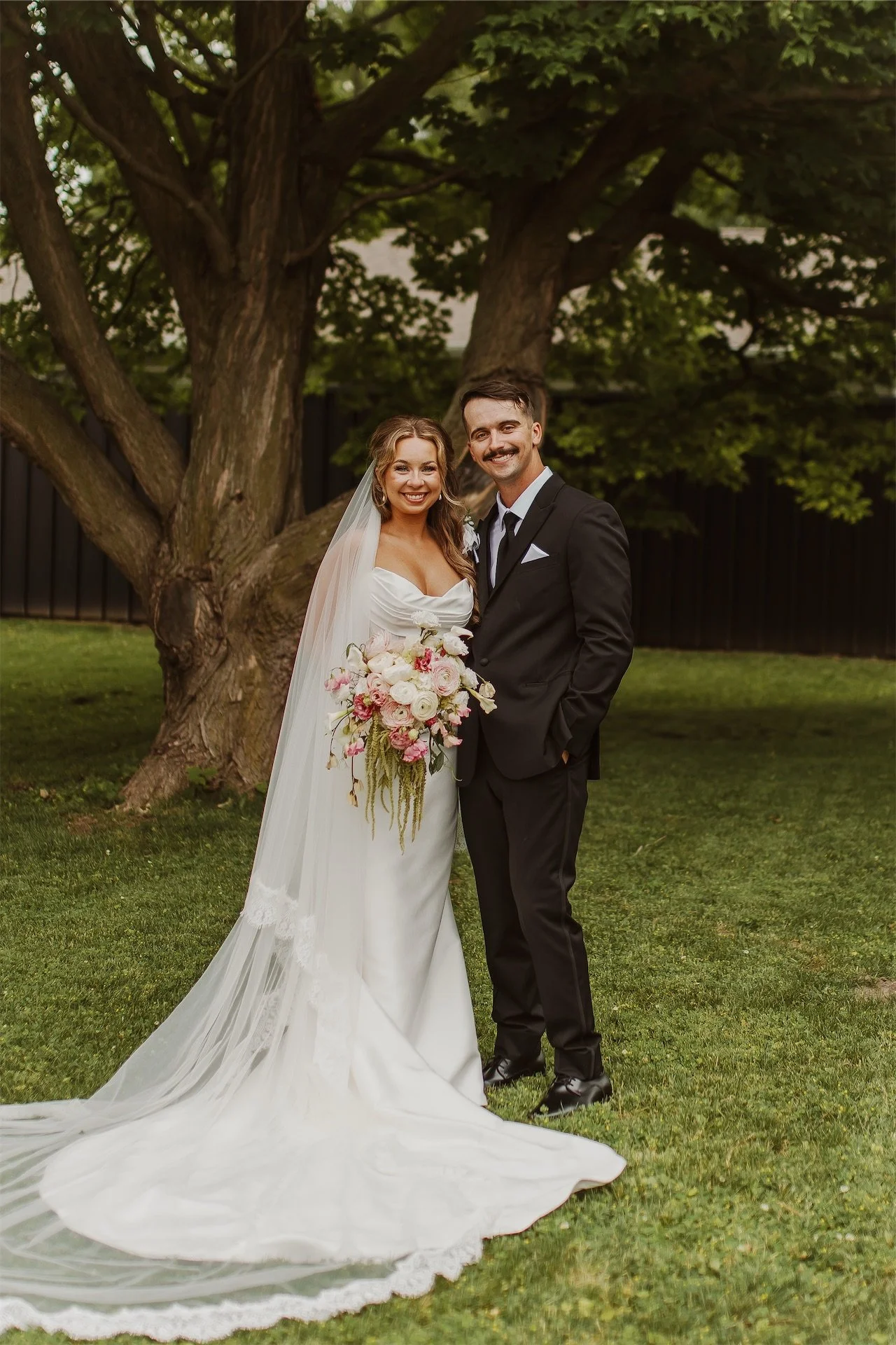 bride and groom portrait outside in grass