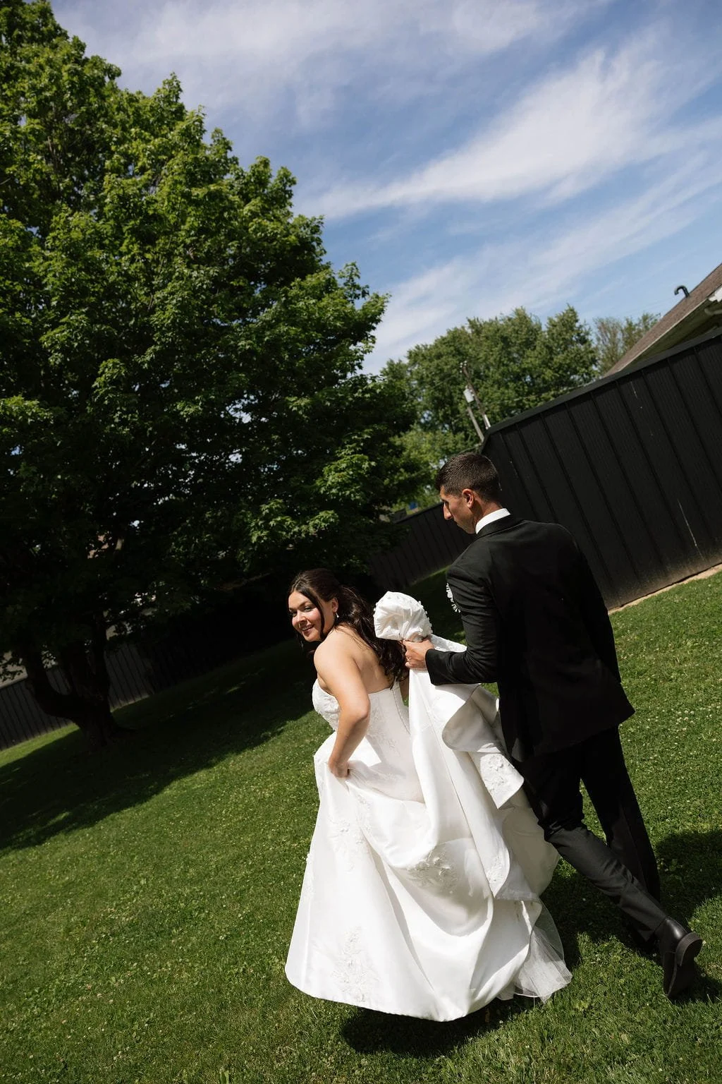 groom-walks-behind-bride-holding-dress-train.jpg