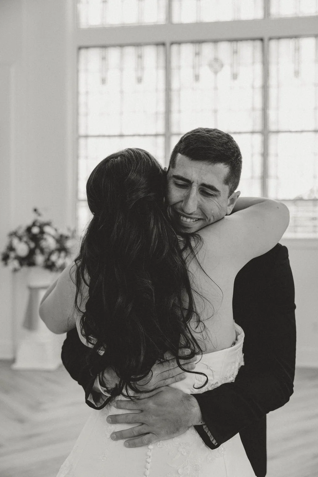 newlywed-couple-embracing-black-and-white.jpg