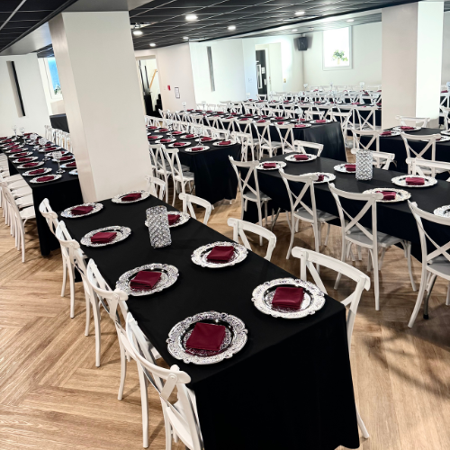 overhead view of a full Gatsby reception room with black linen tables and white chairs