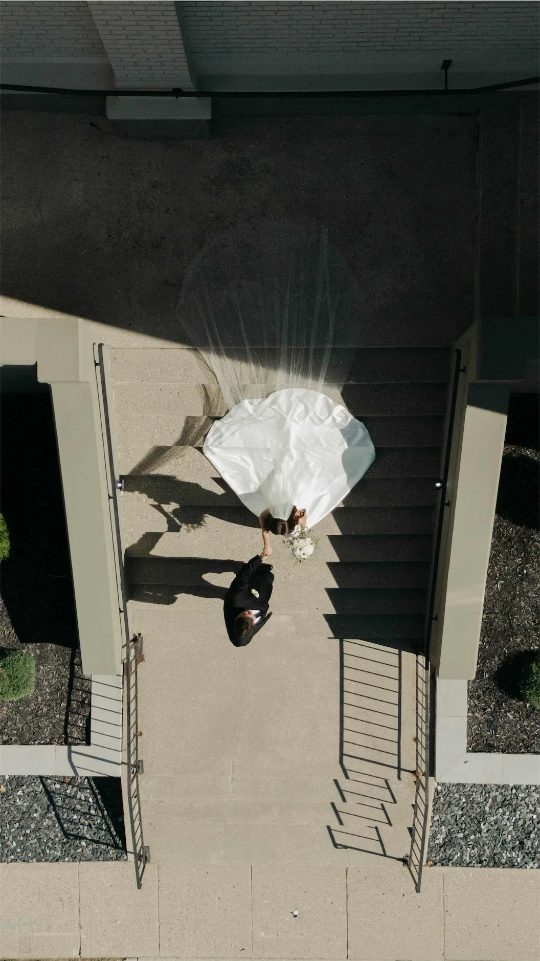 drone-view-bride-groom-front-steps-kaleidoscope-wedding-venue.webp