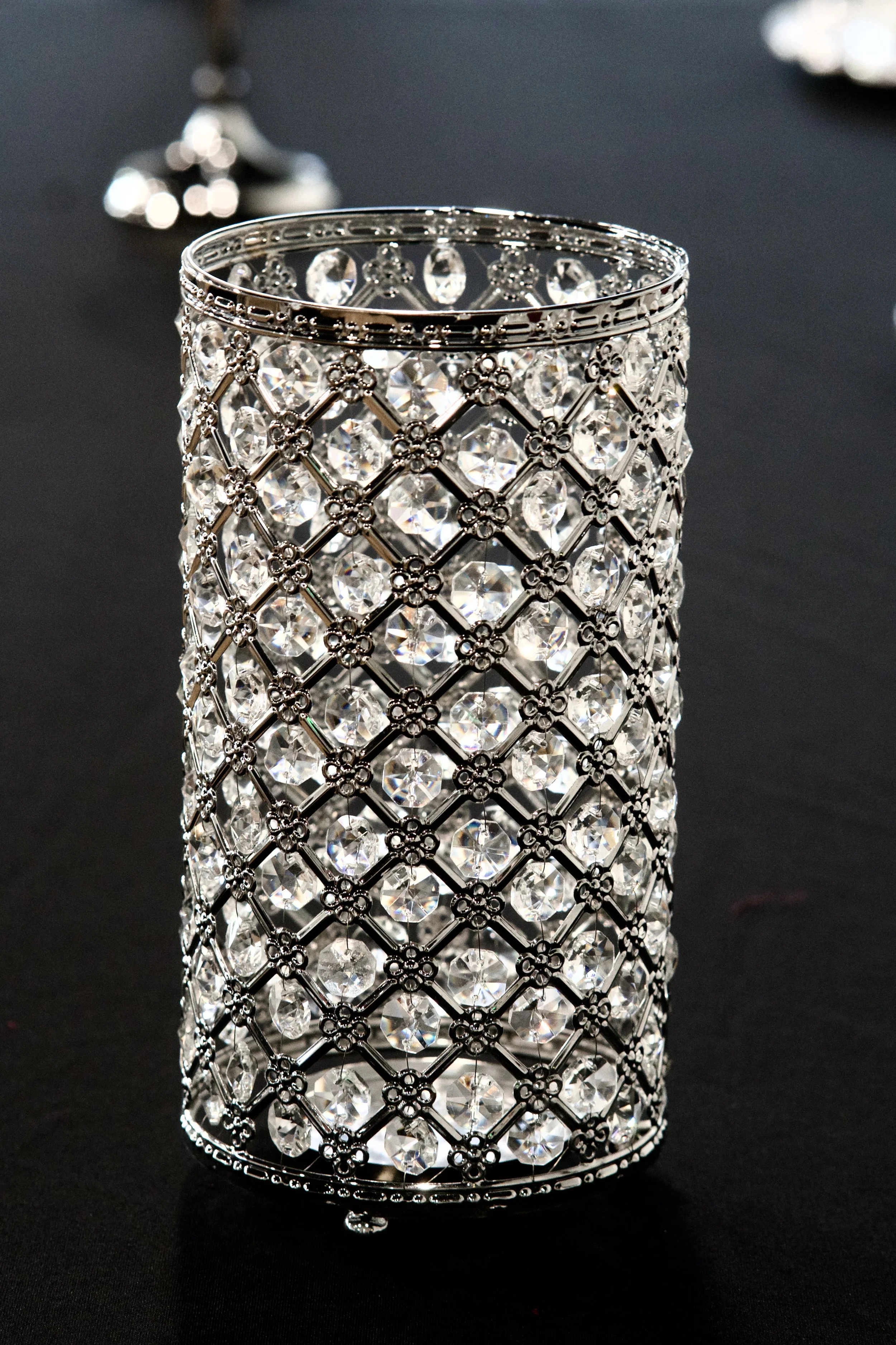 crystal lattice vase catching light on a black linen reception table