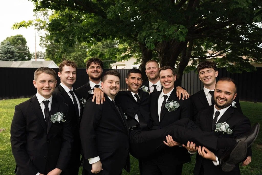 groomsmen-lifting-groom-wedding-portraits.jpg
