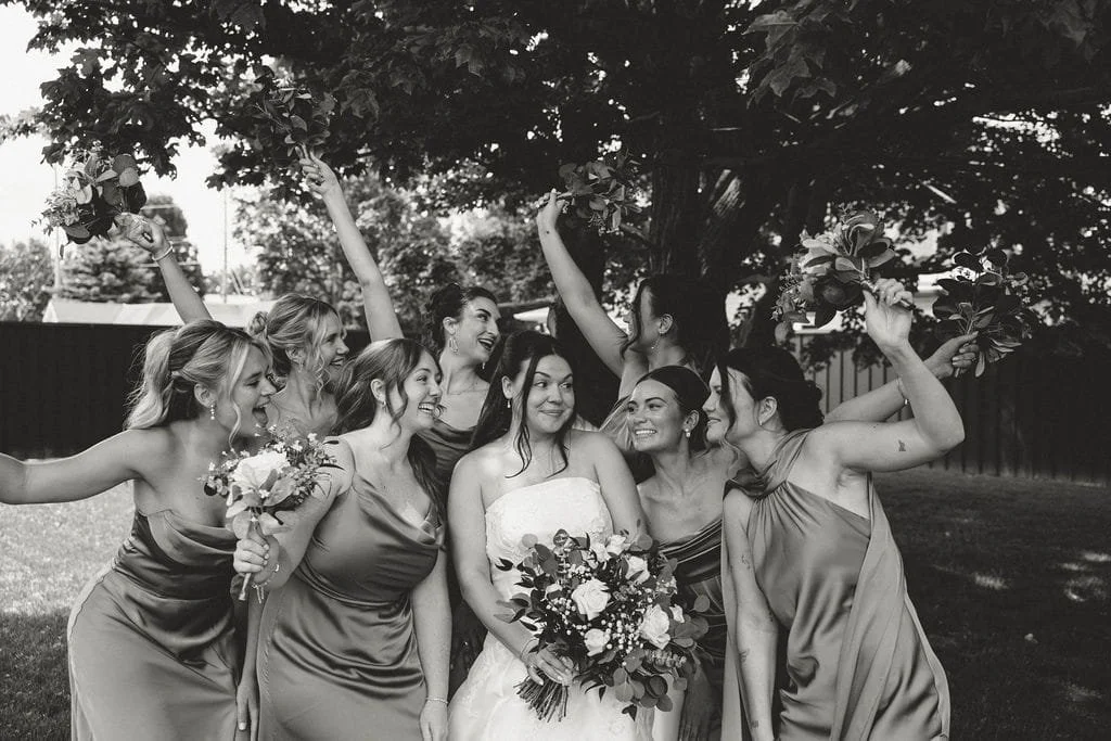 bridesmaids-and-bride-celebrating-outside-black-and-white.jpg