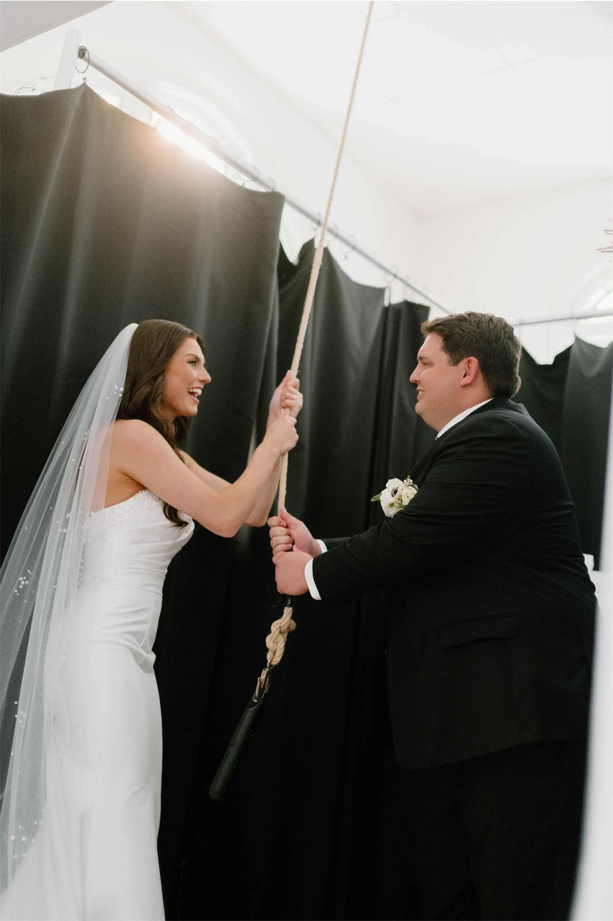 bride-groom-ringing-chapel-bell-after-ceremony.webp