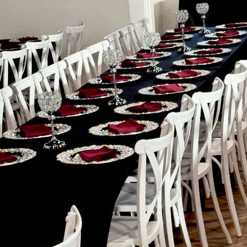 overhead view of crystal goblet centerpieces spaced along a black reception table