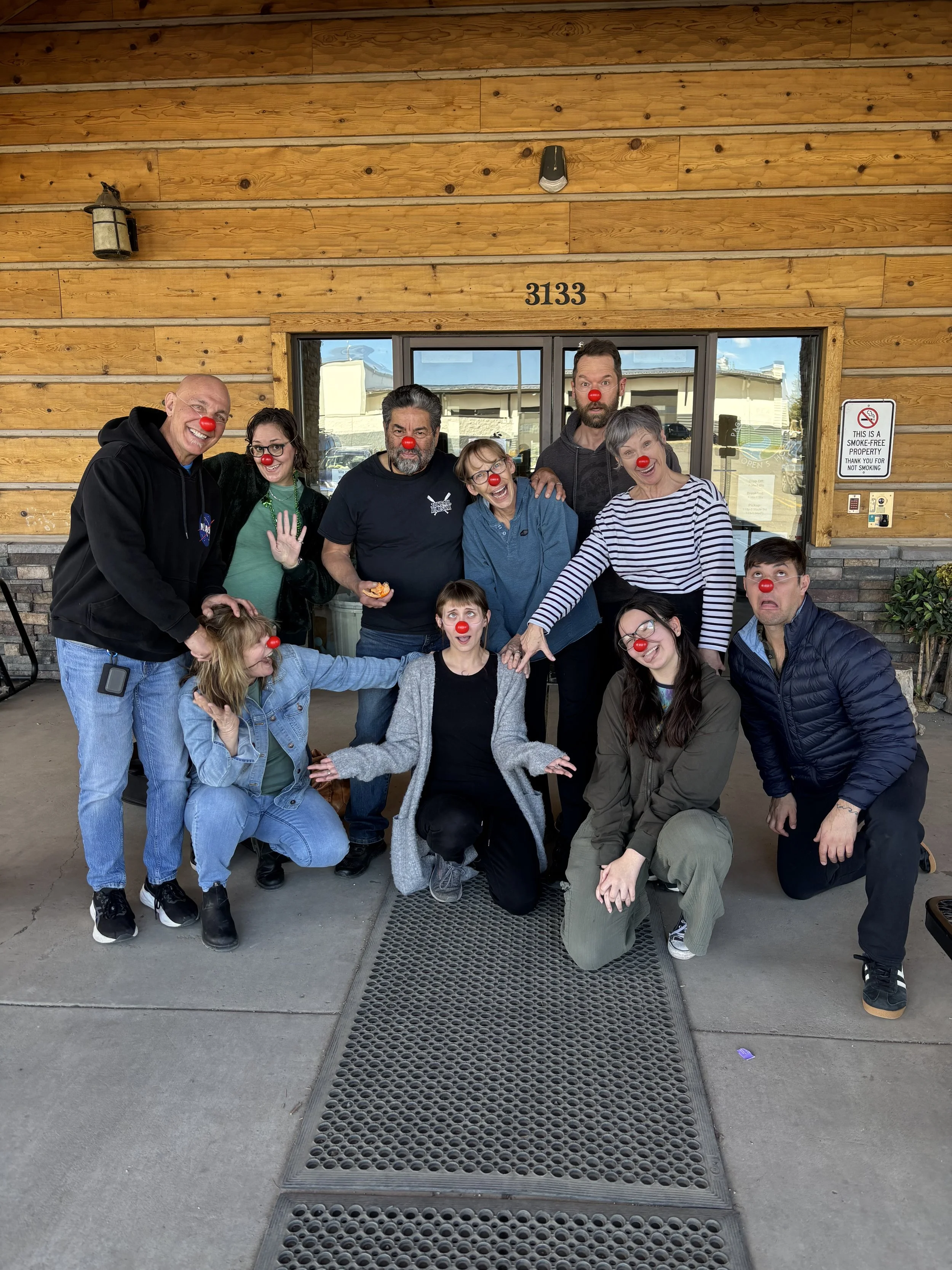 A group of people goofing in red clown noses