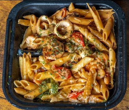 Pasta with shrimp, octopus, and vegetables in a creamy sauce