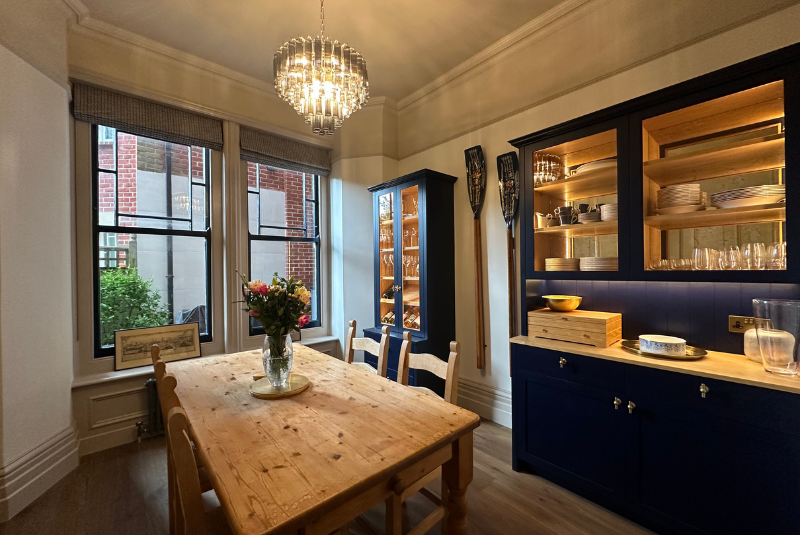 Bold colours and integrated lighting make the cabinetry pop in the dining room