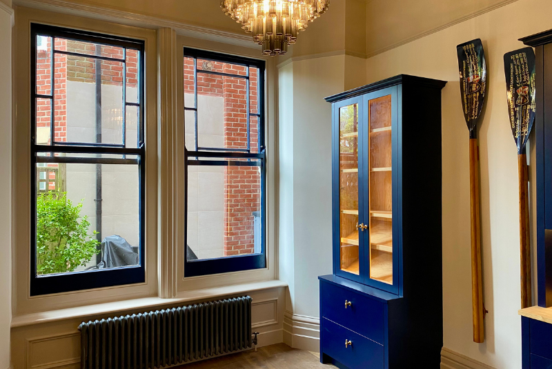 Dark paint picks out the window frames, cabinets and period radiators