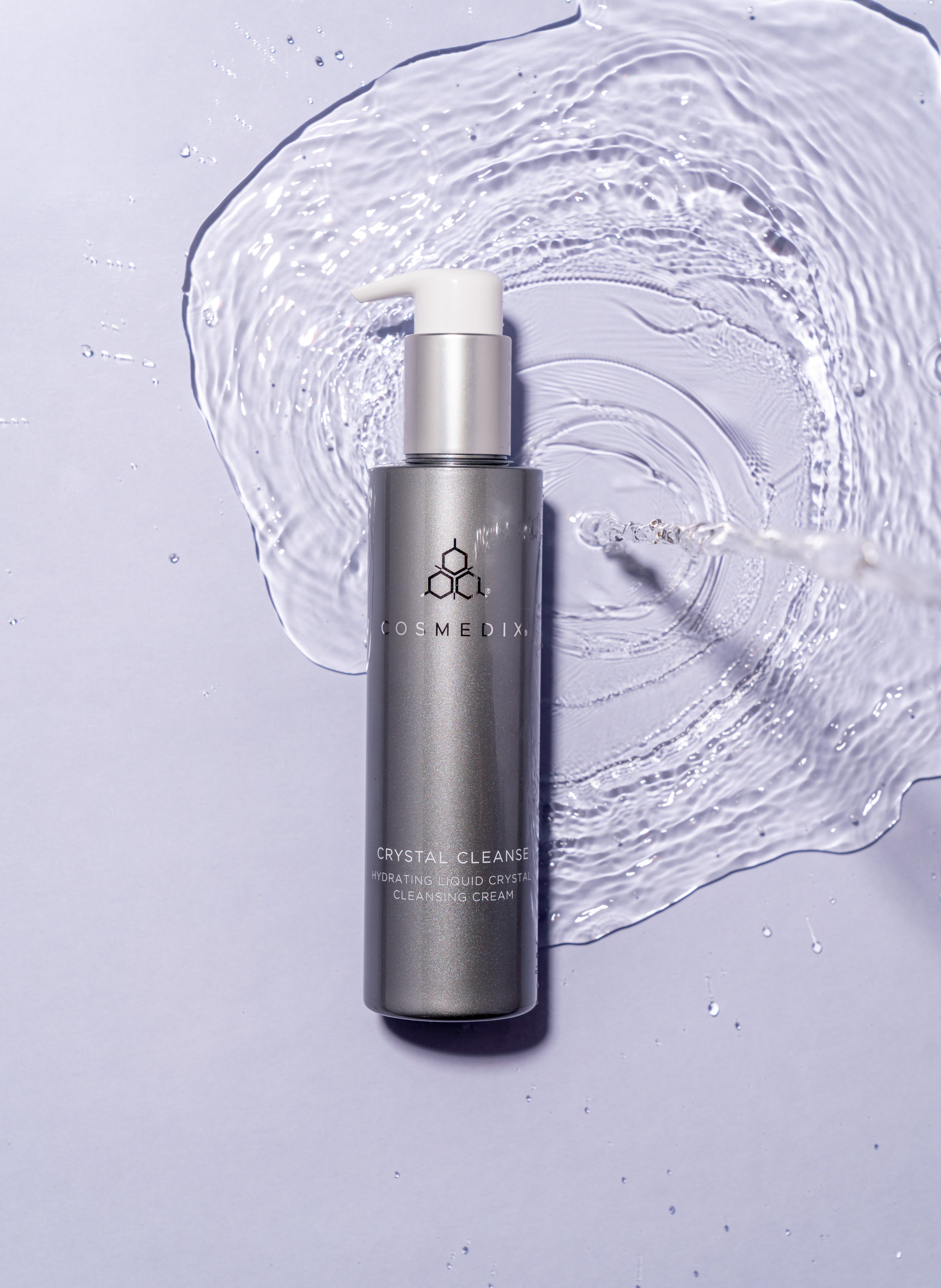 Crystal Cleanse Liquid Crystal Cream Cleanser product bottle with blue background and circling water