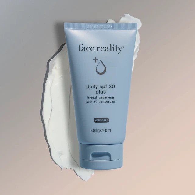 Face Reality Daily SPF 30 Plus with product swatch behind bottle