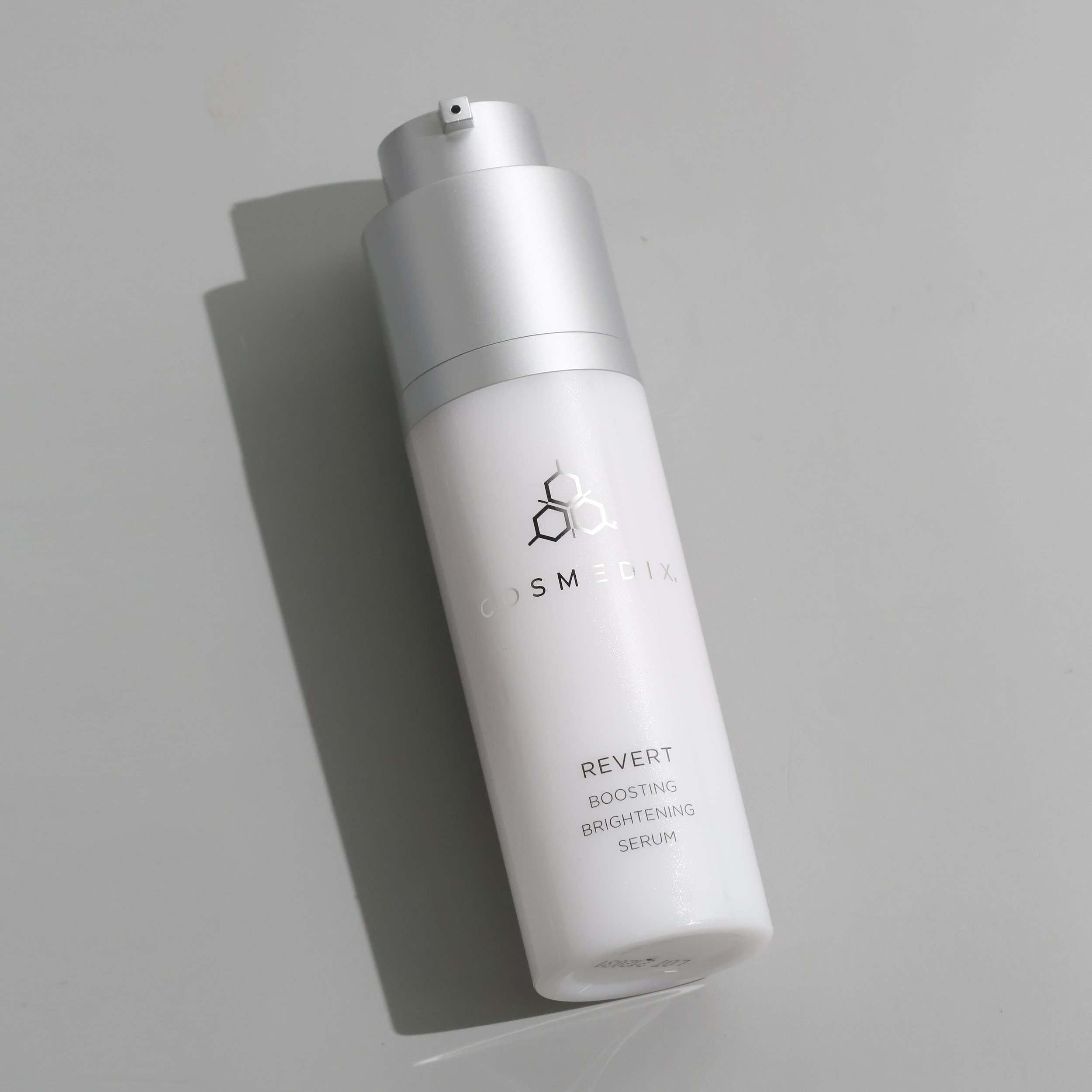 Revert Boosting Brightening Serum product bottle on grey background