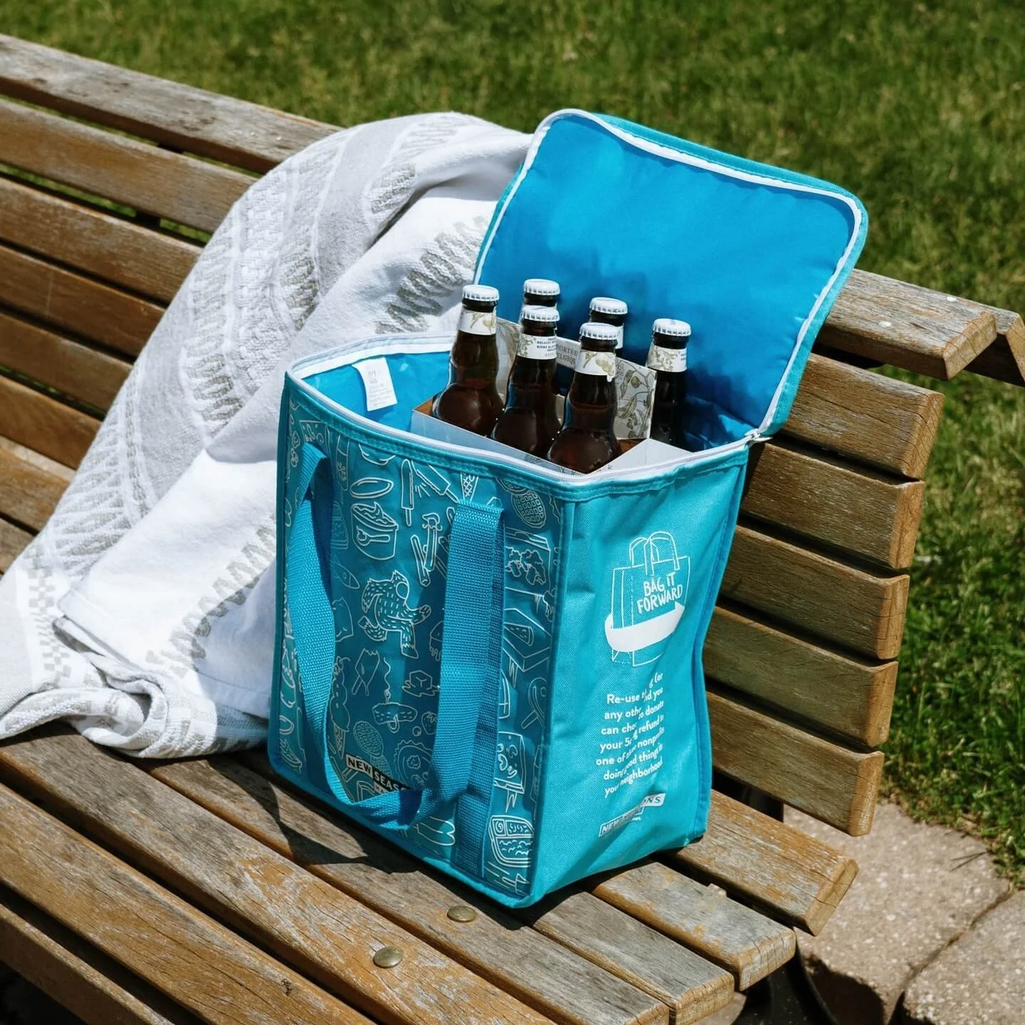 Insulated bag on a bench filled with cold beer