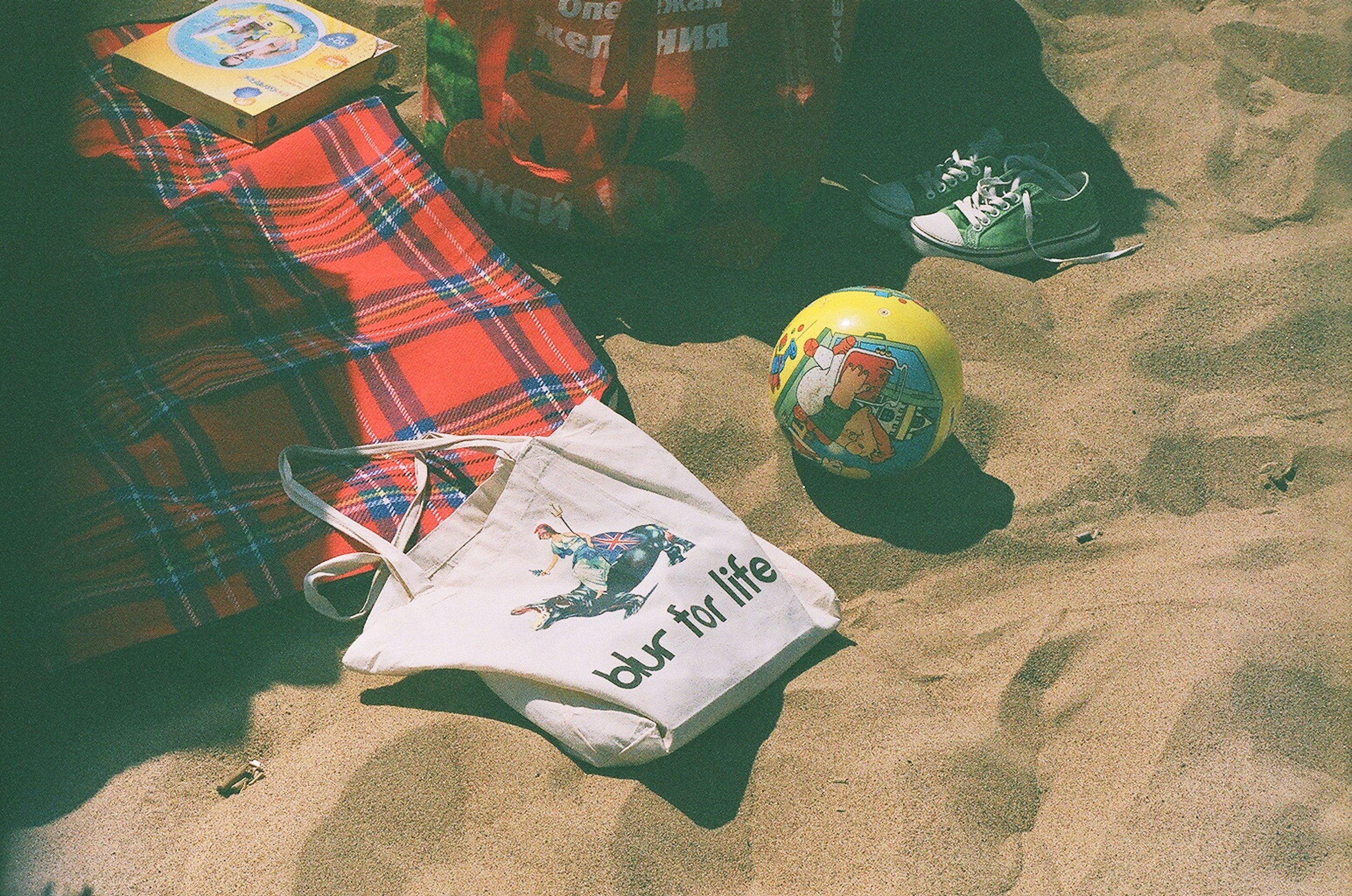 Sandy beach with a volley ball and reusable bag