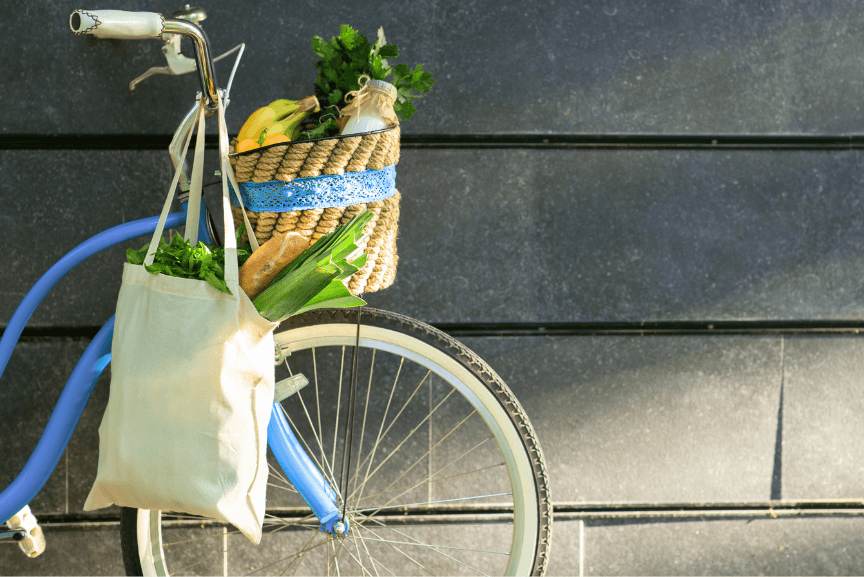 Reusable cotton shopping bag hanging on a bicycle handlebar