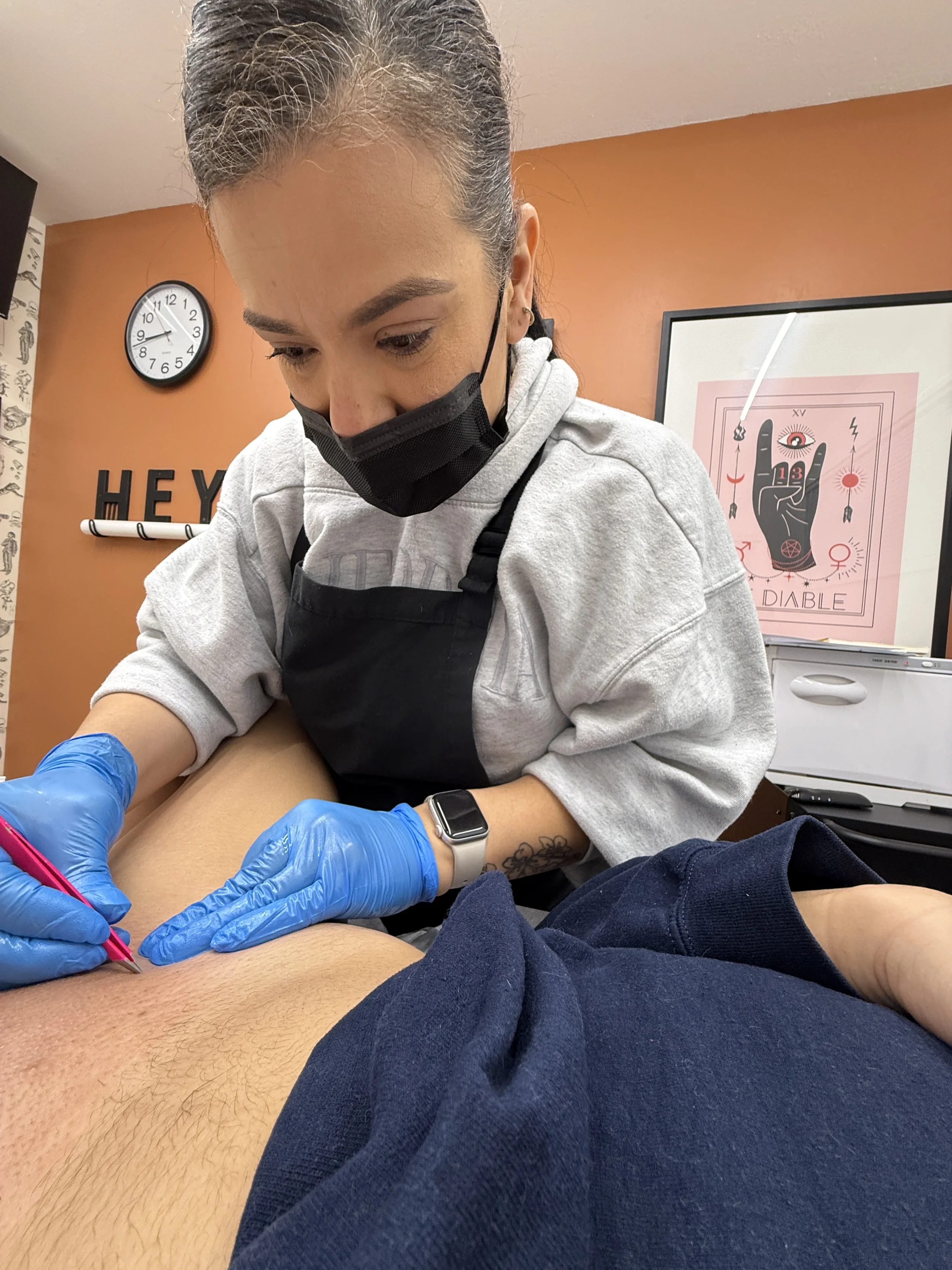 photo of waxer tweezing remaining hairs after brazilian wax
