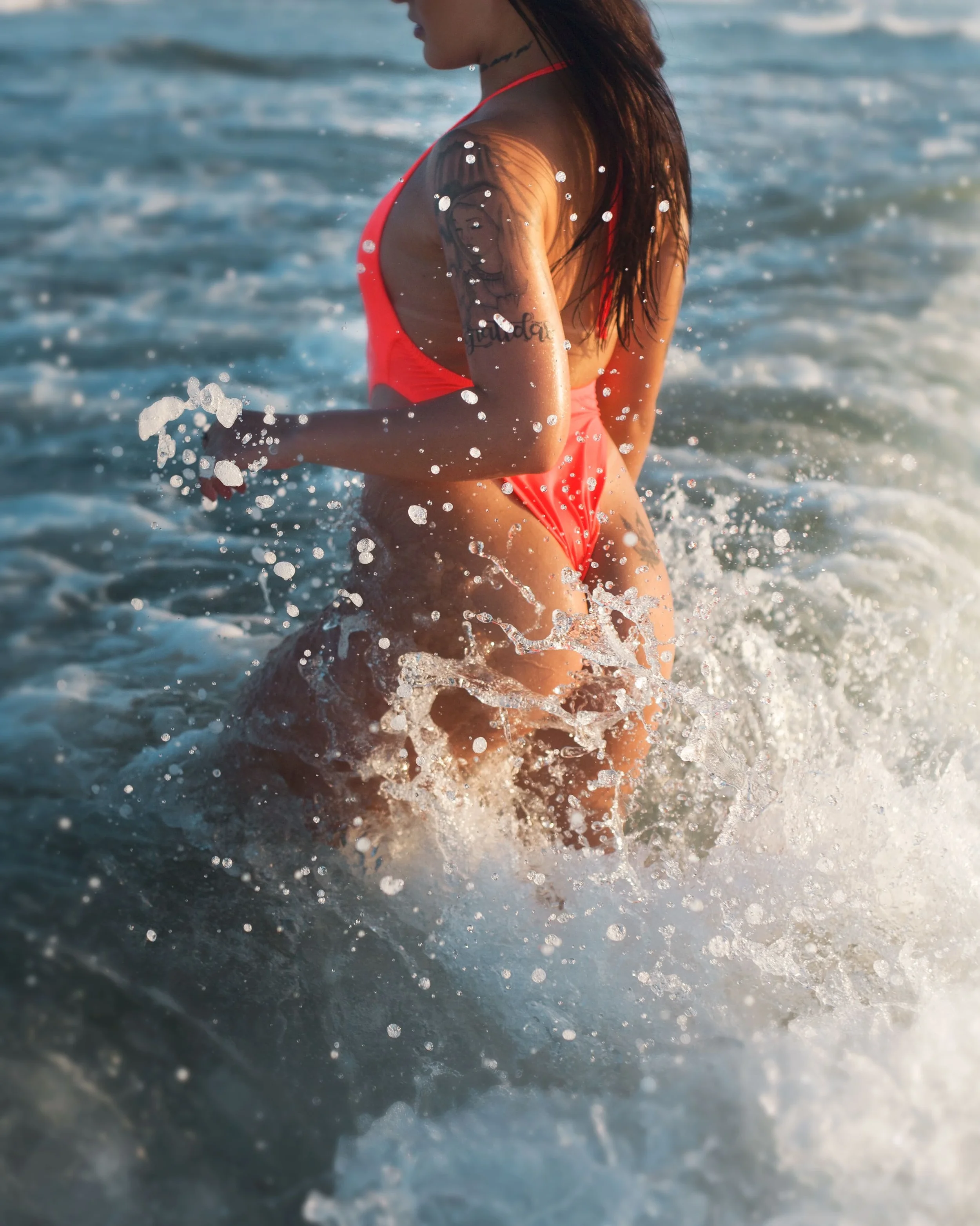IMG5-photo-of-a-person-in-a-bathing-suit-splashing-in-the-surf.webp