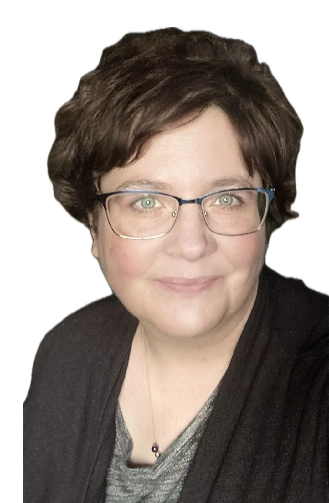 A woman with short brown hair, glasses, and light skin, smiling and wearing a dark top with a necklace.