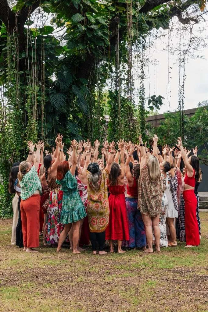 Empowered women entrepreneurs celebrating together in the jungle at Amber Hagberg's Here For More Live retreat