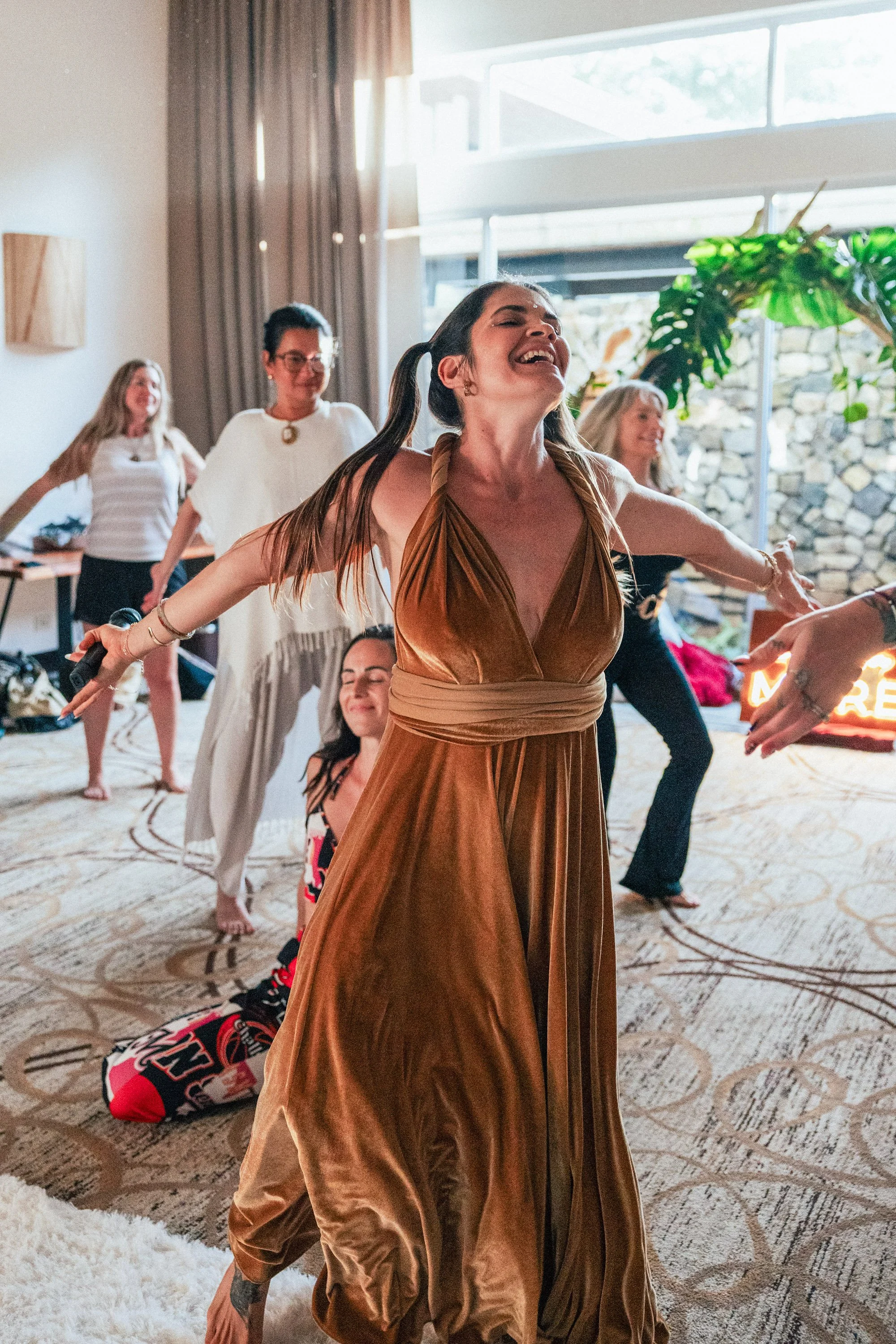 Joyful celebration dance at Here For More Live, Amber Hagberg's spiritual business retreat for women entrepreneurs