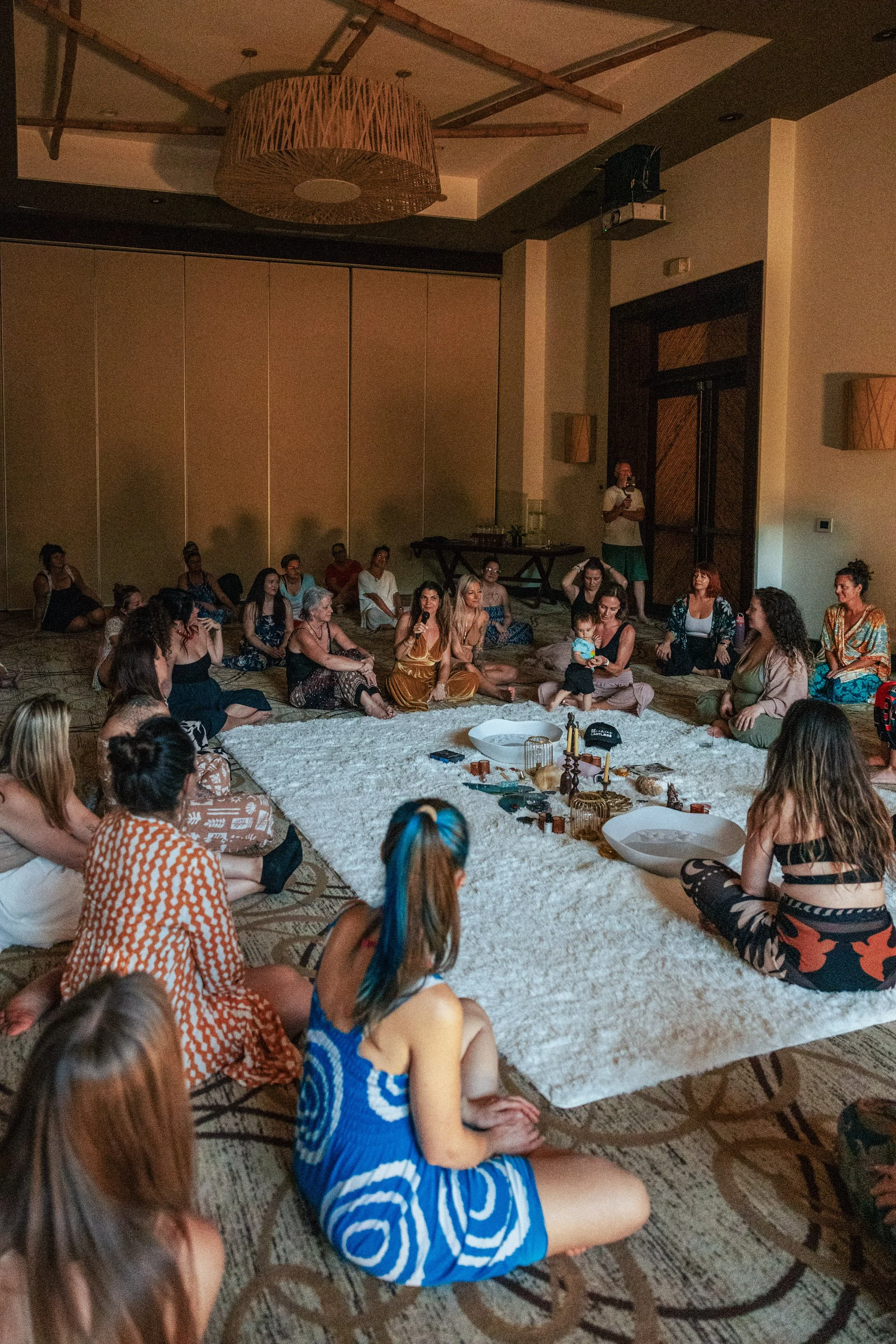 Women entrepreneurs in a group circle sharing session at Here For More Live retreat in Costa Rica