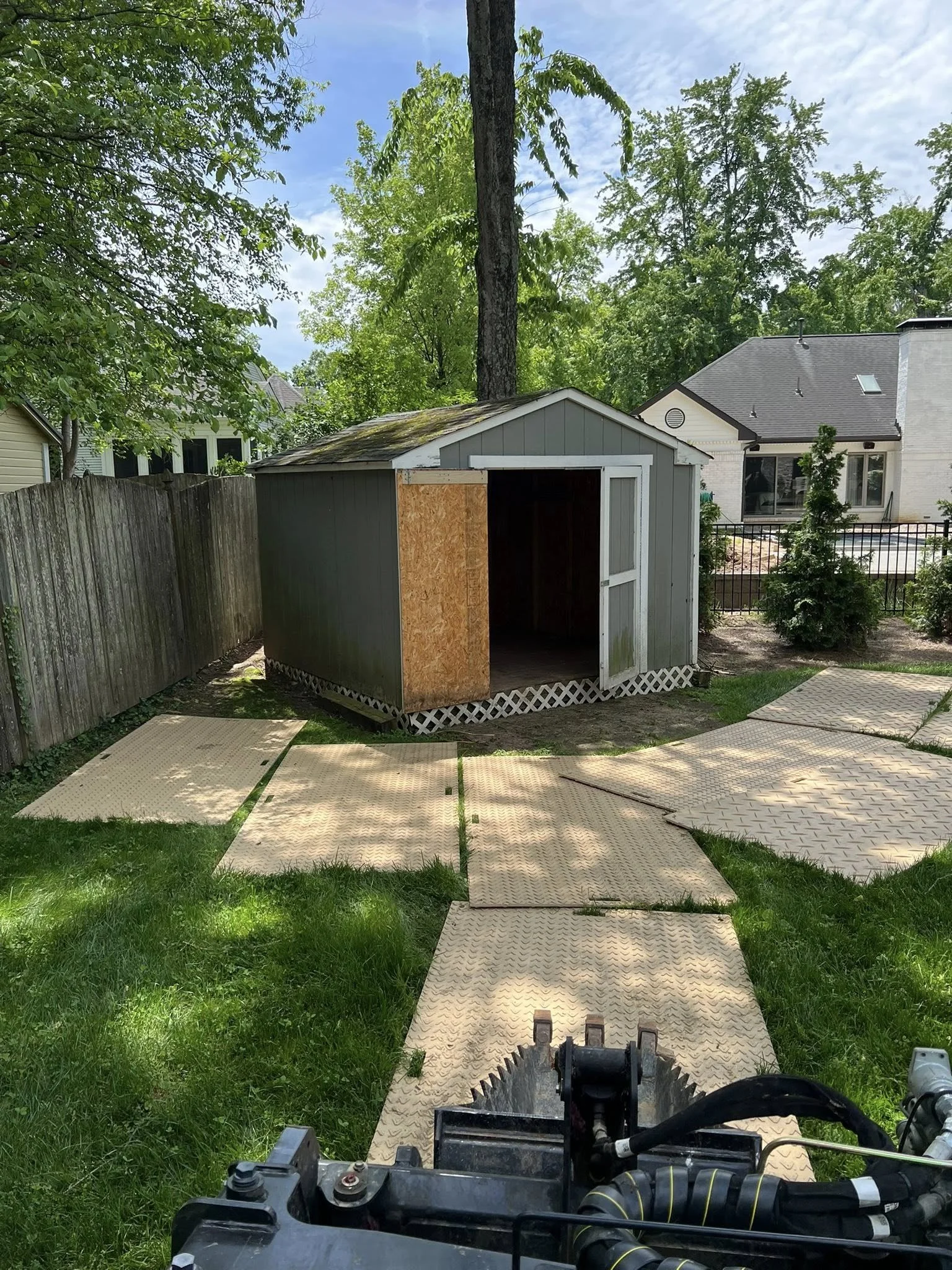 Tight-access shed demolition with compact equipment and ground protection mats in Greater Cincinnati