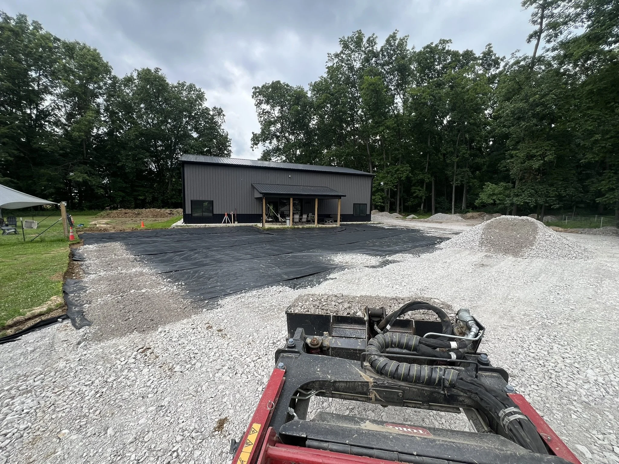 Gravel driveway installation with geotextile fabric and compact equipment in Greater Cincinnati