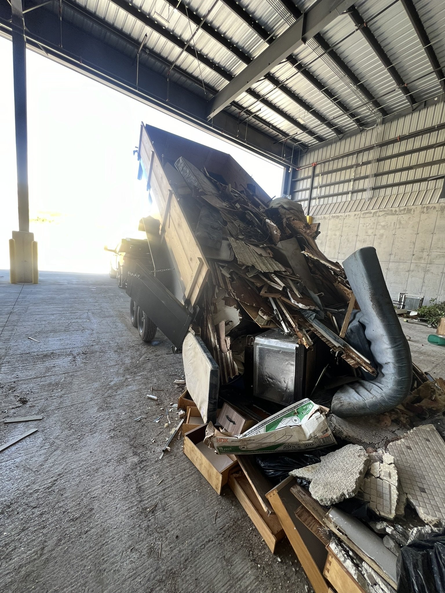 Dump trailer unloading demolition debris after a structure removal project in Greater Cincinnati
