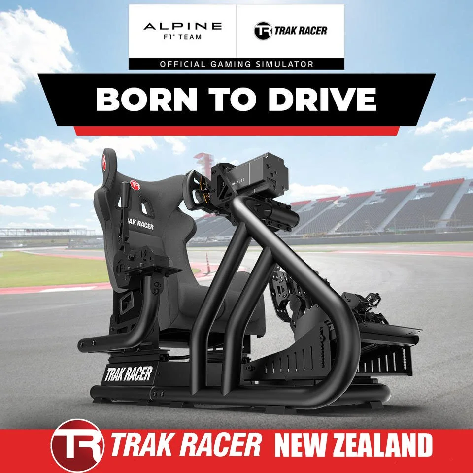 Promotional image of an advanced racing simulator setup with a racing seat, steering wheel, and pedals, on a race track with stadium stands in the background. The text reads 'Born to Drive' and features logos for Alpine F1 Team and Trak Racer, indicating a New Zealand location.