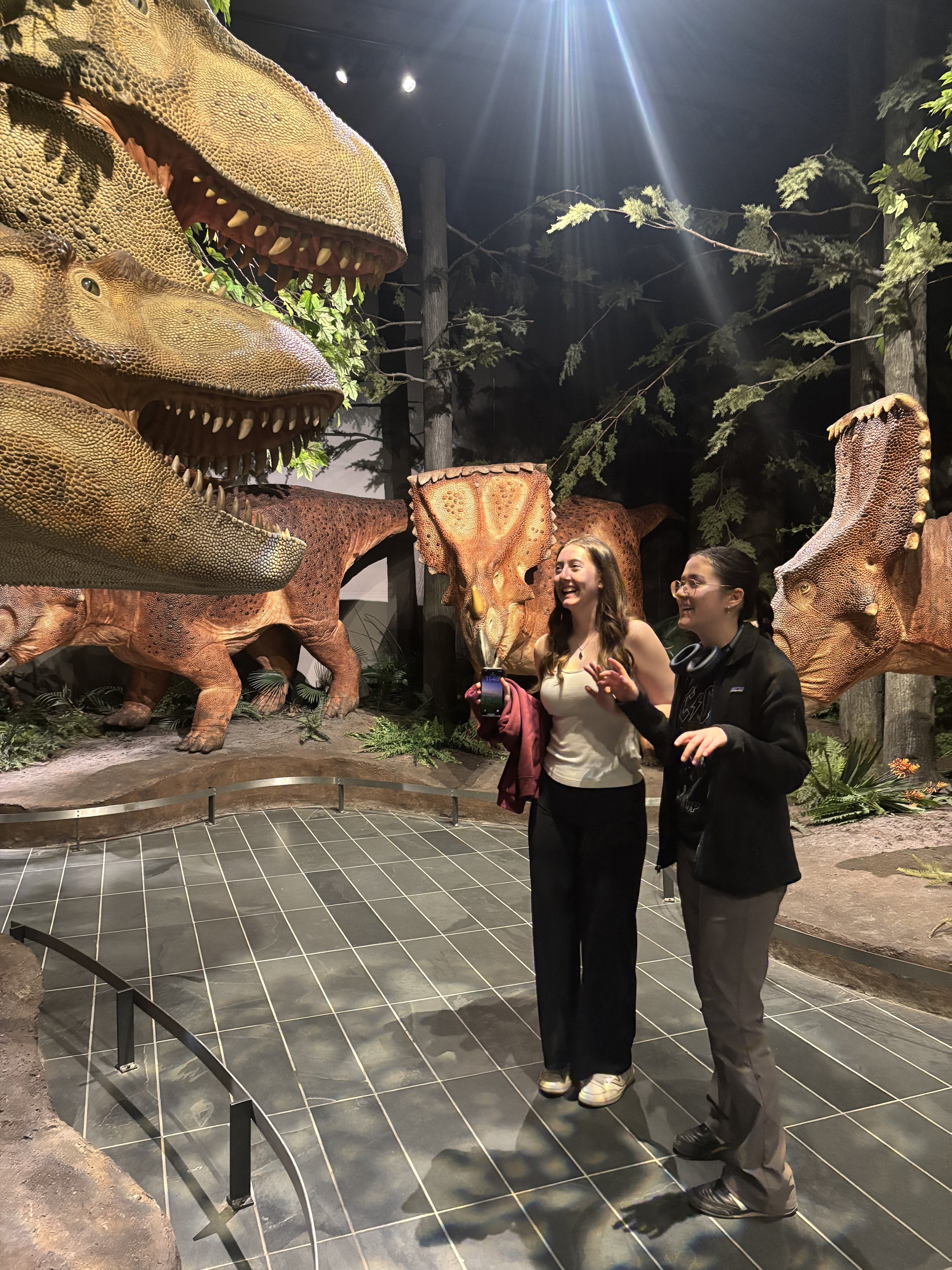 Maranda and Zoe either frightened of or imitating a T-rex at the Canadian Museum of Nature