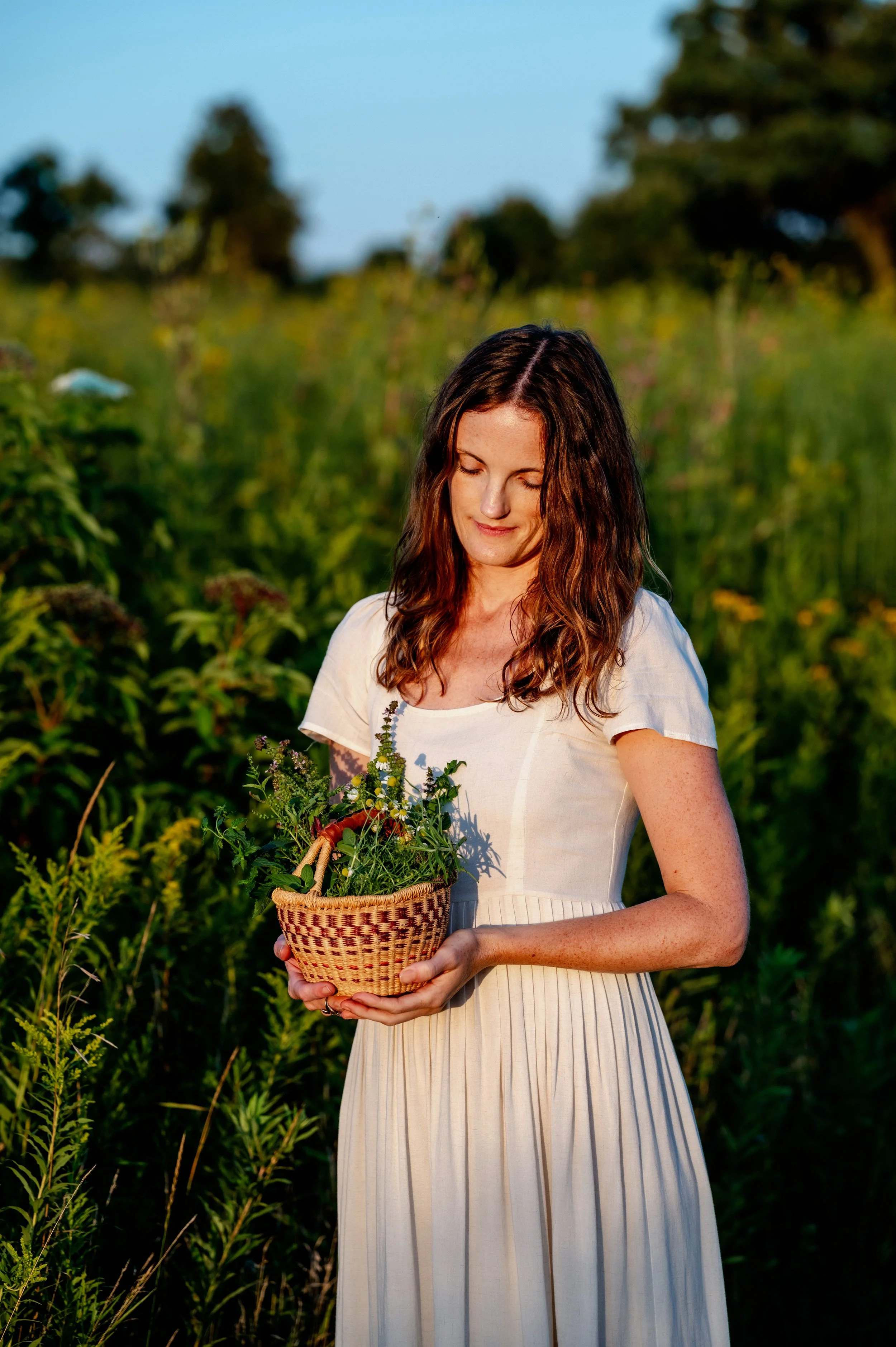 Emily holding a basket of fresh herbs