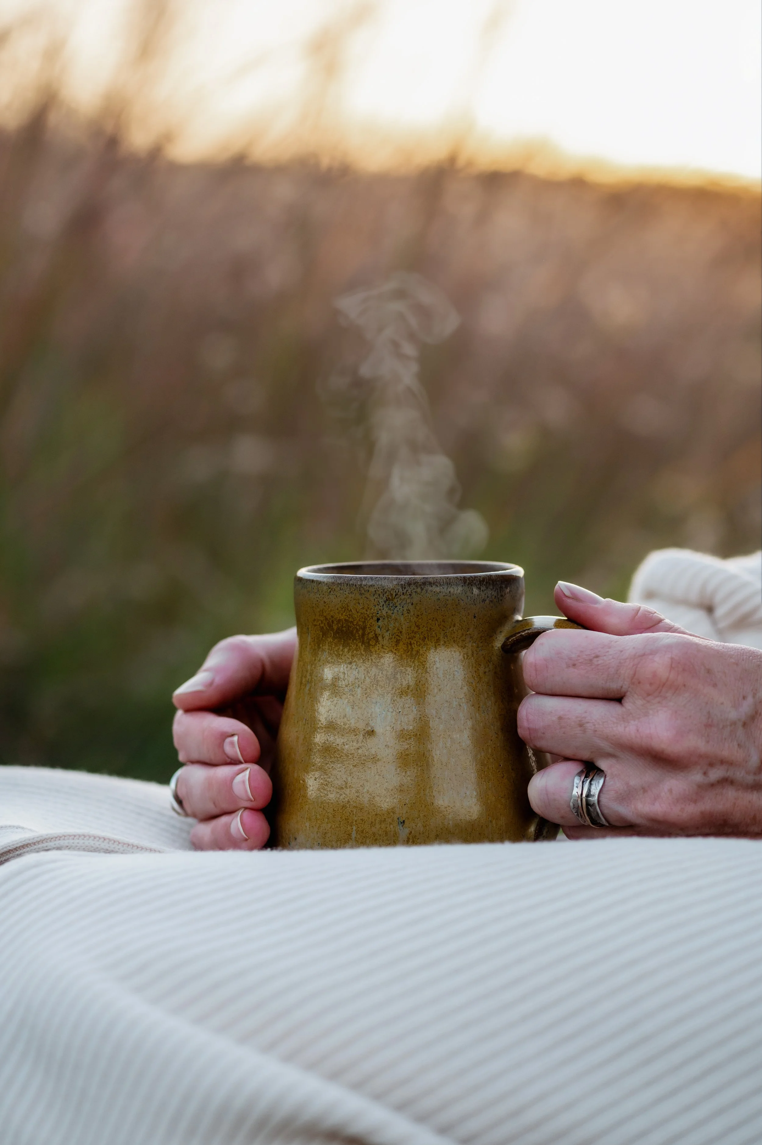 Hands holding mug of hot tea
