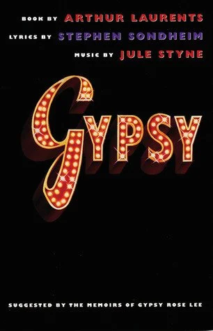 The cover of a book titled 'Gypsy' with the author's name, Arthur Laurents, at the top, and others credited with lyrics by Stephen Sondheim and music by Jule Styne. The title is displayed in large, illuminated letters.