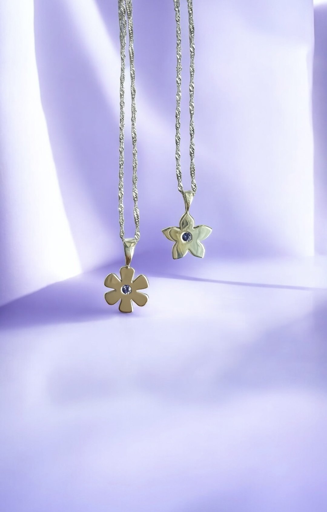 Silver flowers set with vibrant purple sapphire