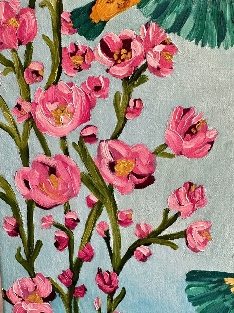 Kingfishers in Flight is an original oil painting by Australian artist Cassie Holmes, and features three beautiful kingfisher birds flying amongst some beautiful soft pink flowers.