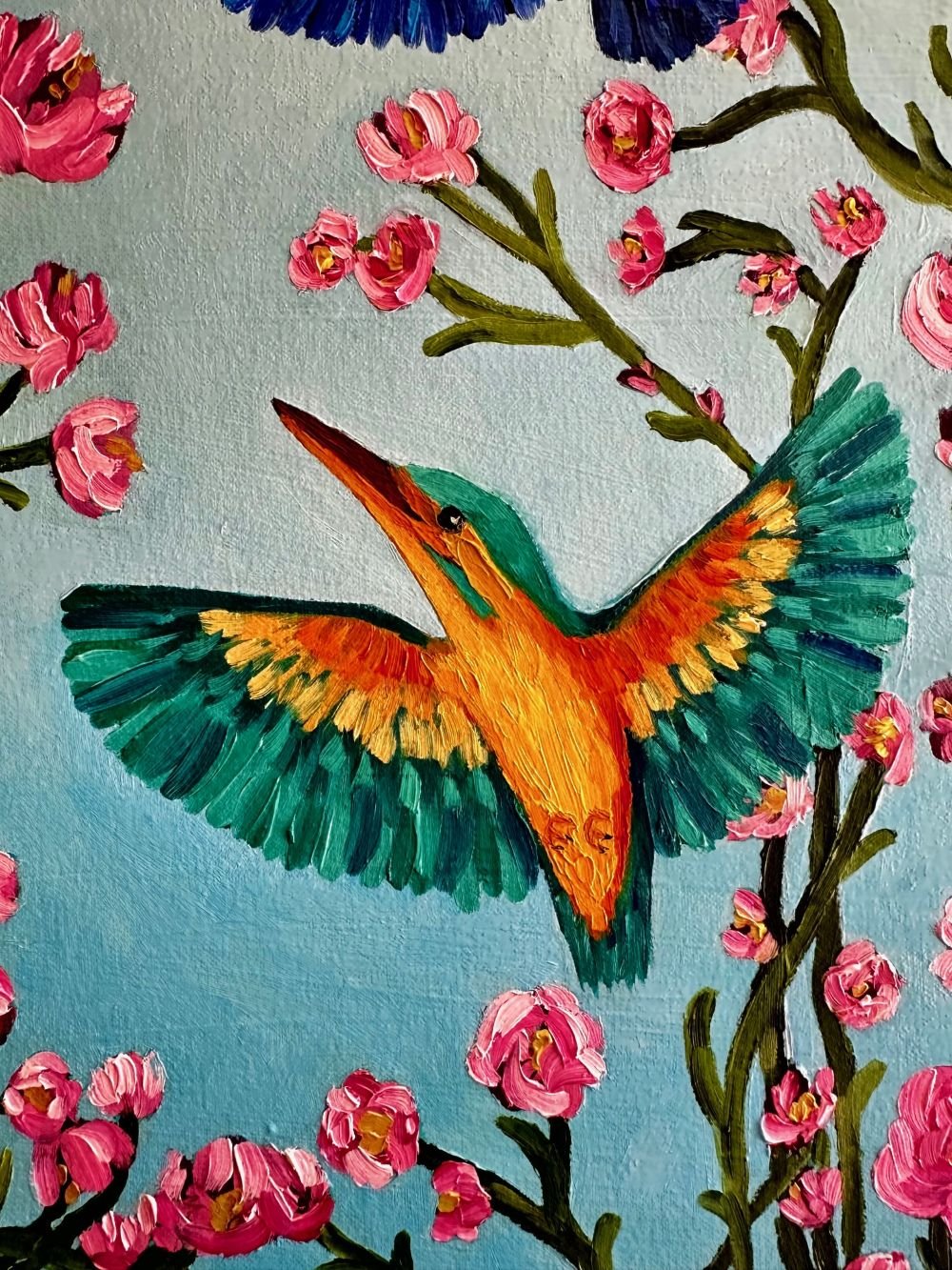 Kingfishers in Flight is an original oil painting by Australian artist Cassie Holmes, and features three beautiful kingfisher birds flying amongst some beautiful soft pink flowers.