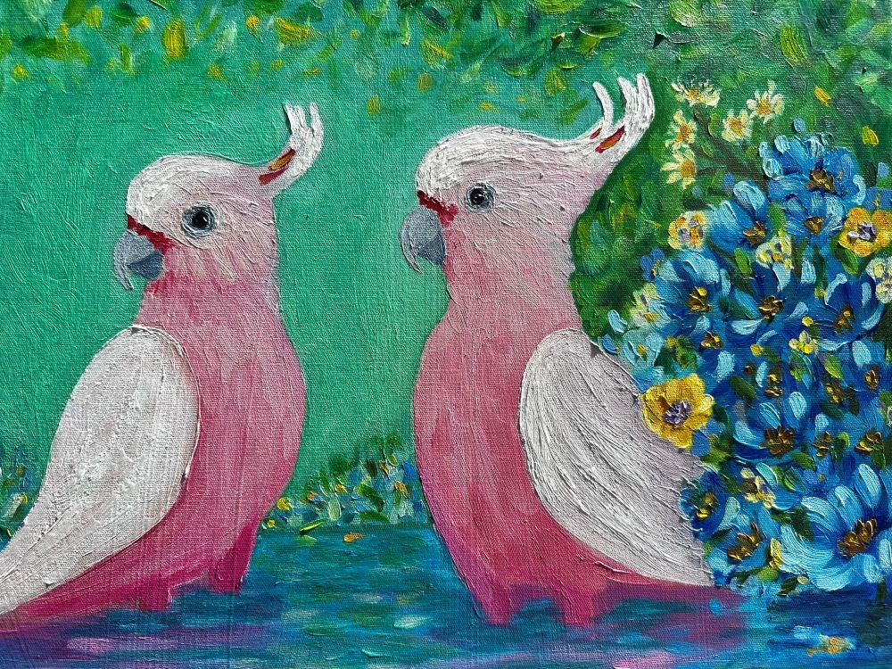 Calm Pink Waters is an original oil painting by Australian artist Cassie Holmes, showing three Pink Cockatoos standing in water surrounded by yellow and blue flowers. Close up.