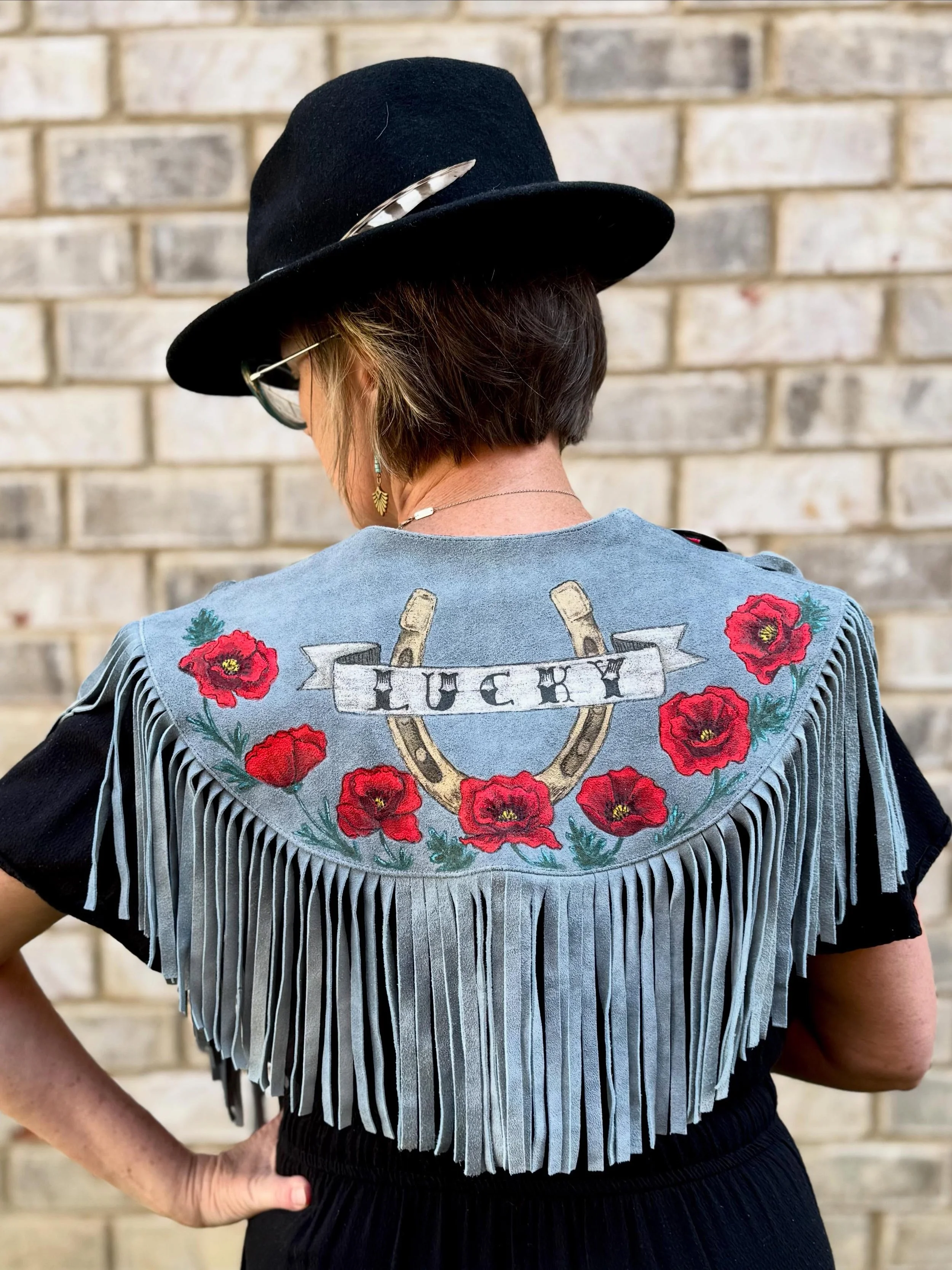 A little custom paint job for @leahtheflystylist to wear for @andbeyondfestival . California poppies with a Tennessee flair. Are you feeling Lucky?🤩

#paintedleather #upcycling #countrycape #wearyourart