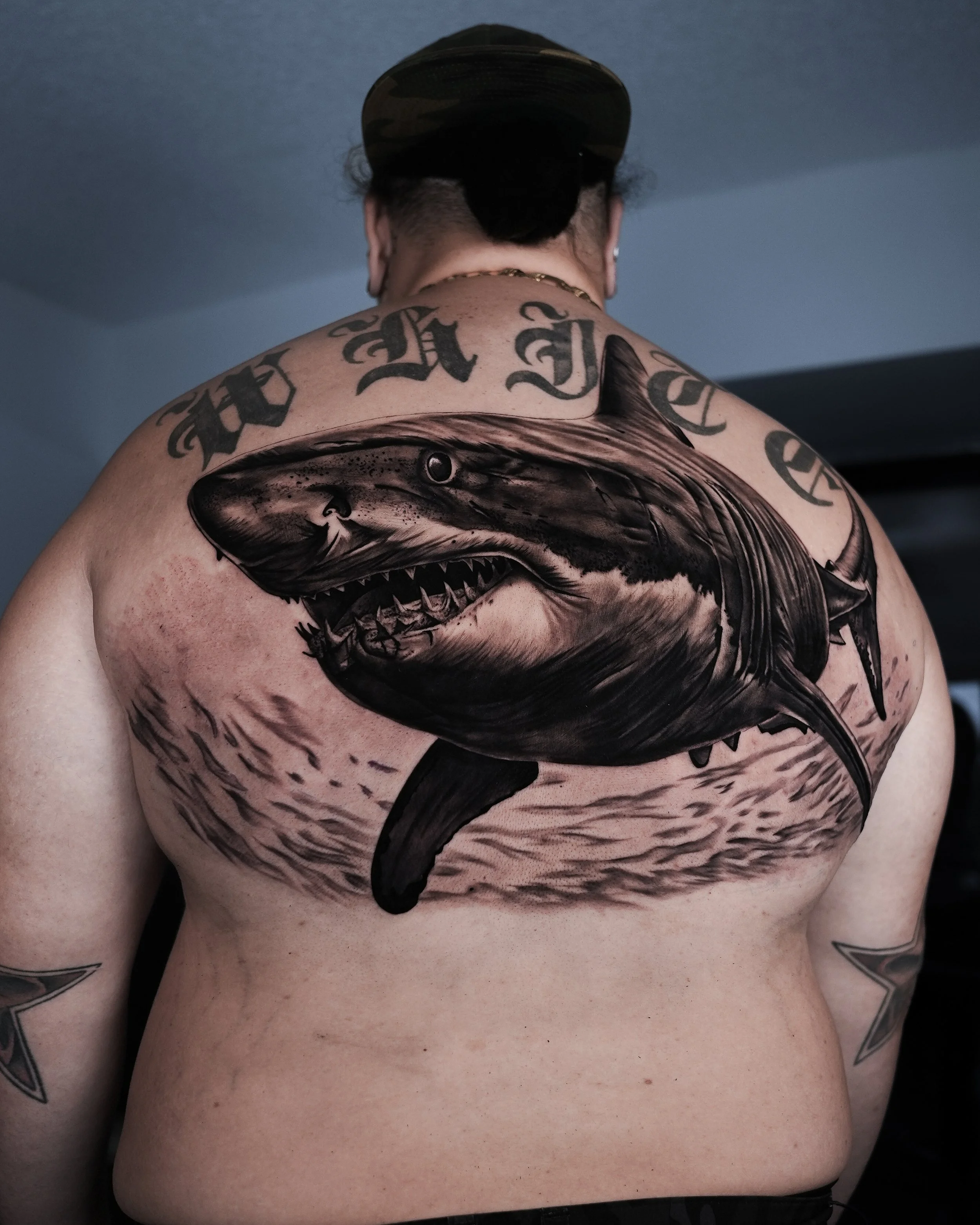 Abstract painting of a seated nude figure with mixed media, featuring bold colors and text "ART NUDE."