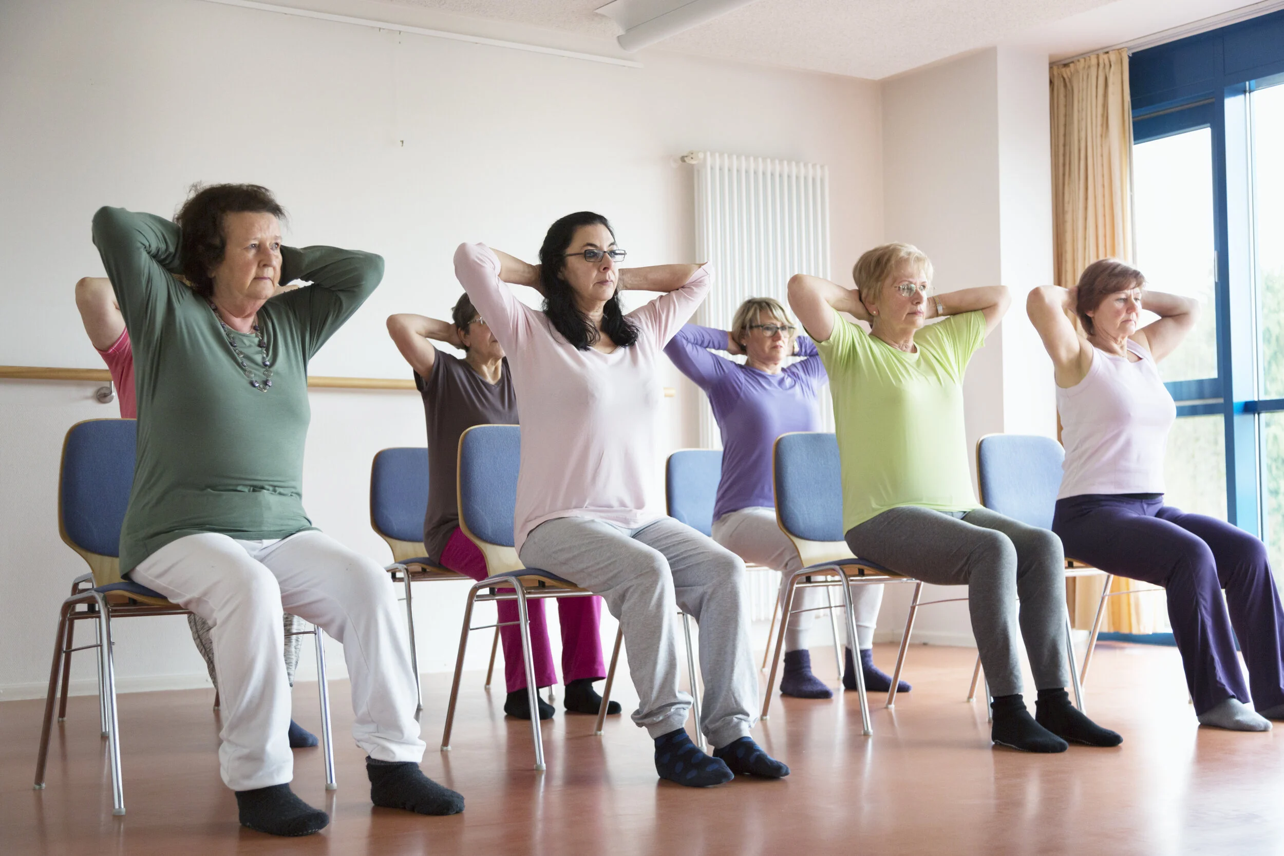 active-senior-women-yoga-class-on-chairs-510589800_5760x3840.jpeg