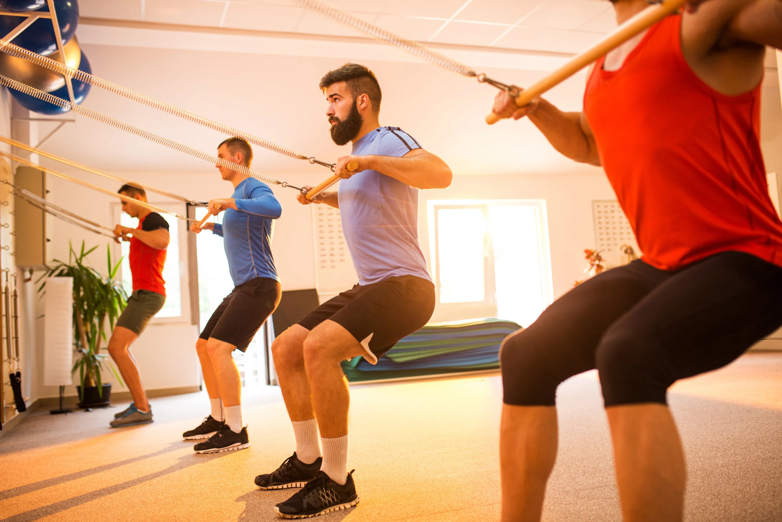 Group-of-sportsmen-exercising-on-Pilates-machines-in-health-club.-637765816_5760x3840.jpeg