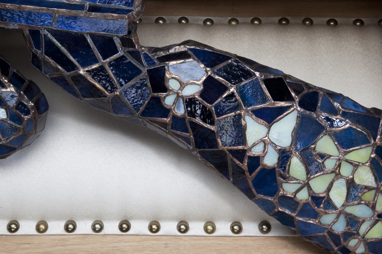 The Mechanization of Freedom (detail), 2011, 70”x60”x16”, copper-foiled glass, solder, wood, steel, upholstered satin