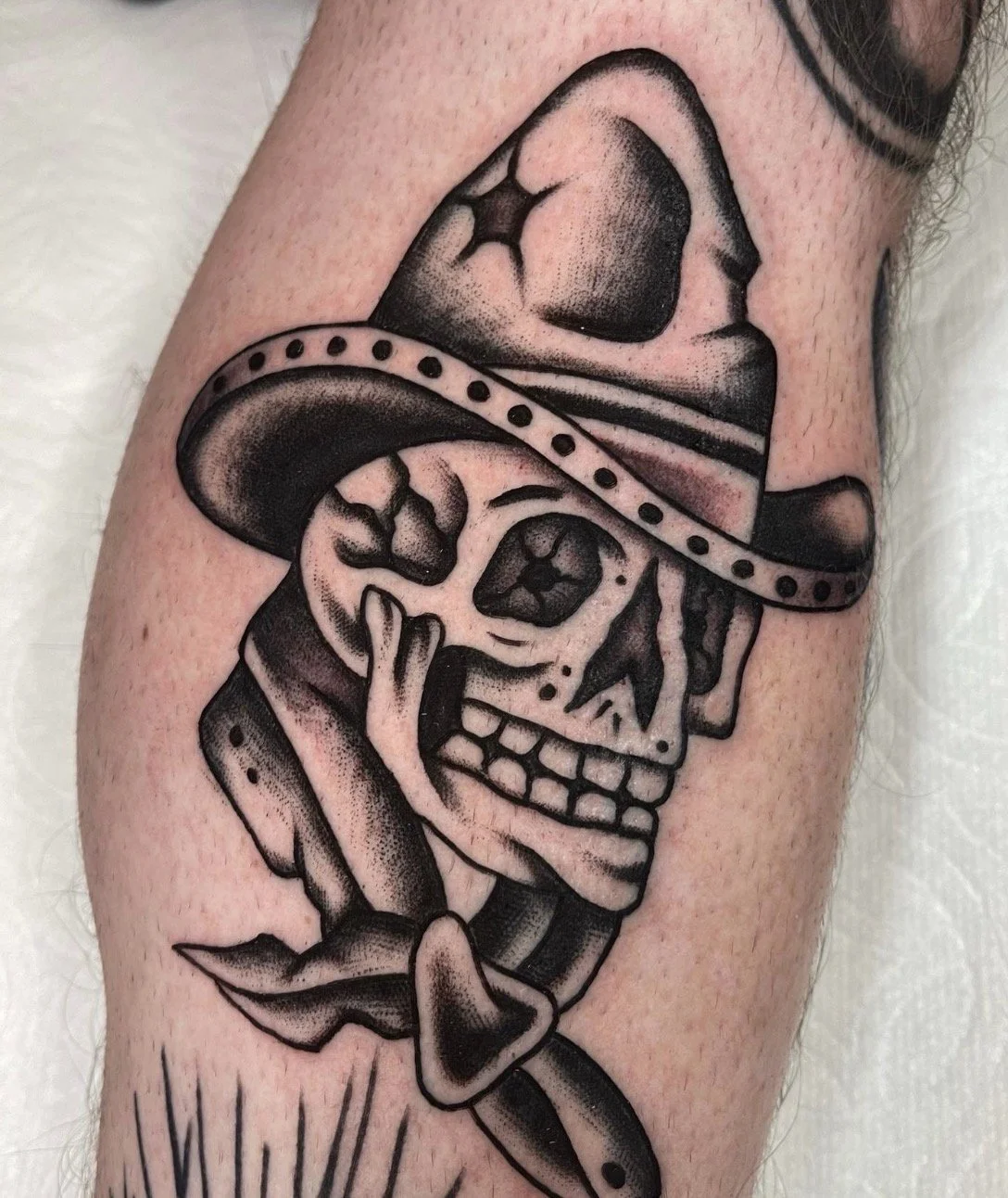 Iconic Tony Polito skull redrawn and tattooed by Casey Sullivan at Rose Tattoo in Point Loma San Diego in California. American traditional style tattoo with strong contrast, clean linework, and vintage flash design influence of cowboy and western