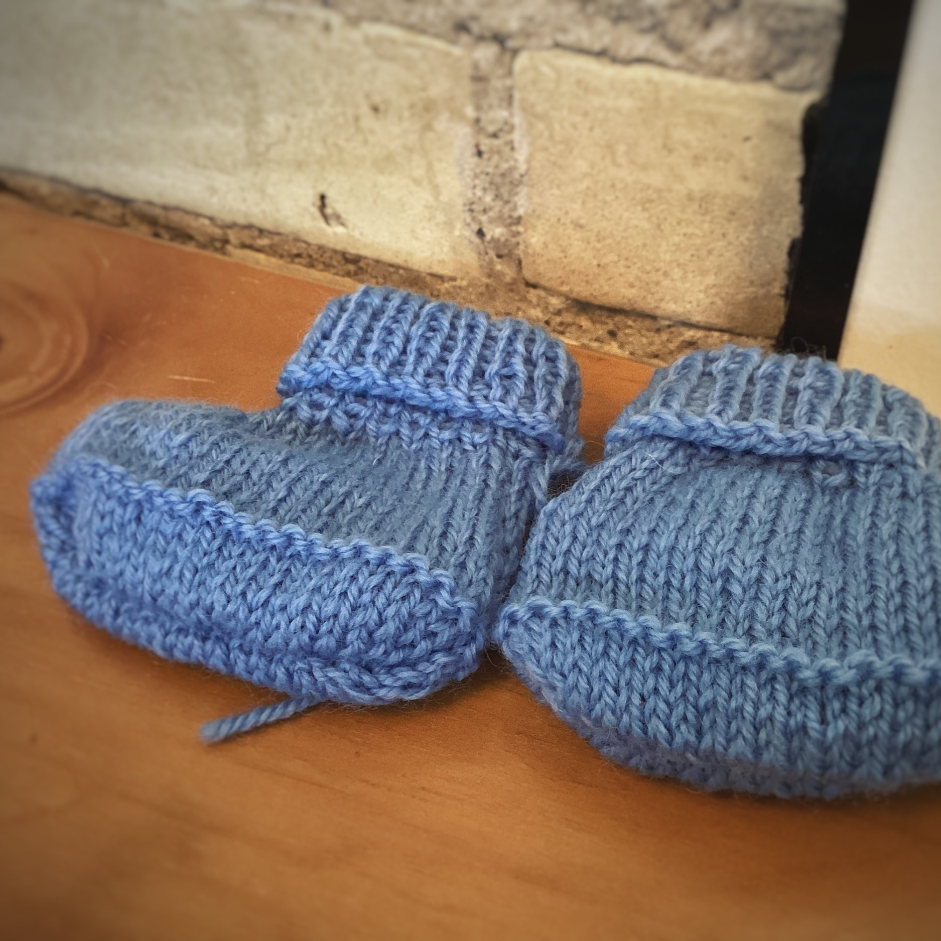 Light blue Scandinavian baby booties, crafted from a cozy wool blend, offering a snug and stylish option for infants and toddlers.